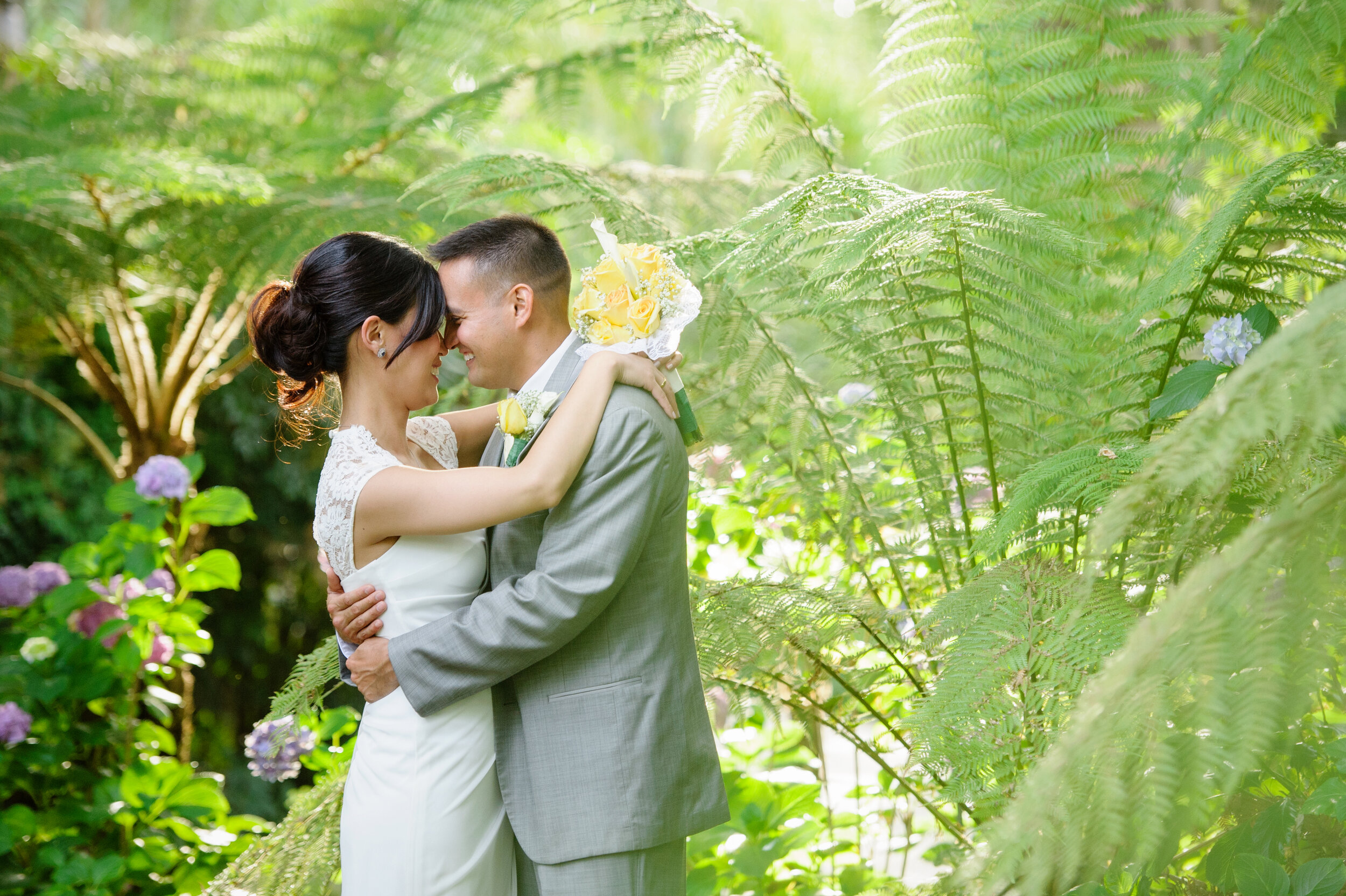 Photo of a bride and groom embracing outdoors