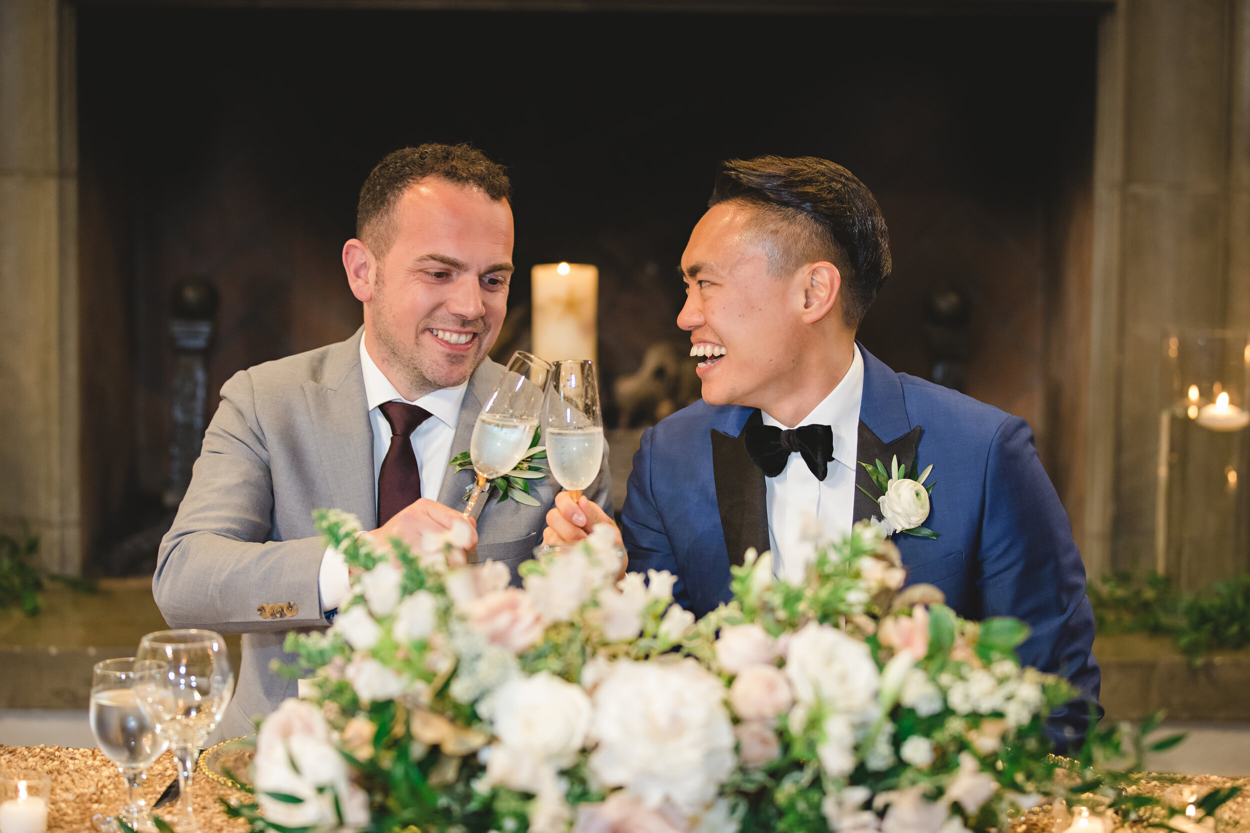 Photo of two grooms laughing together