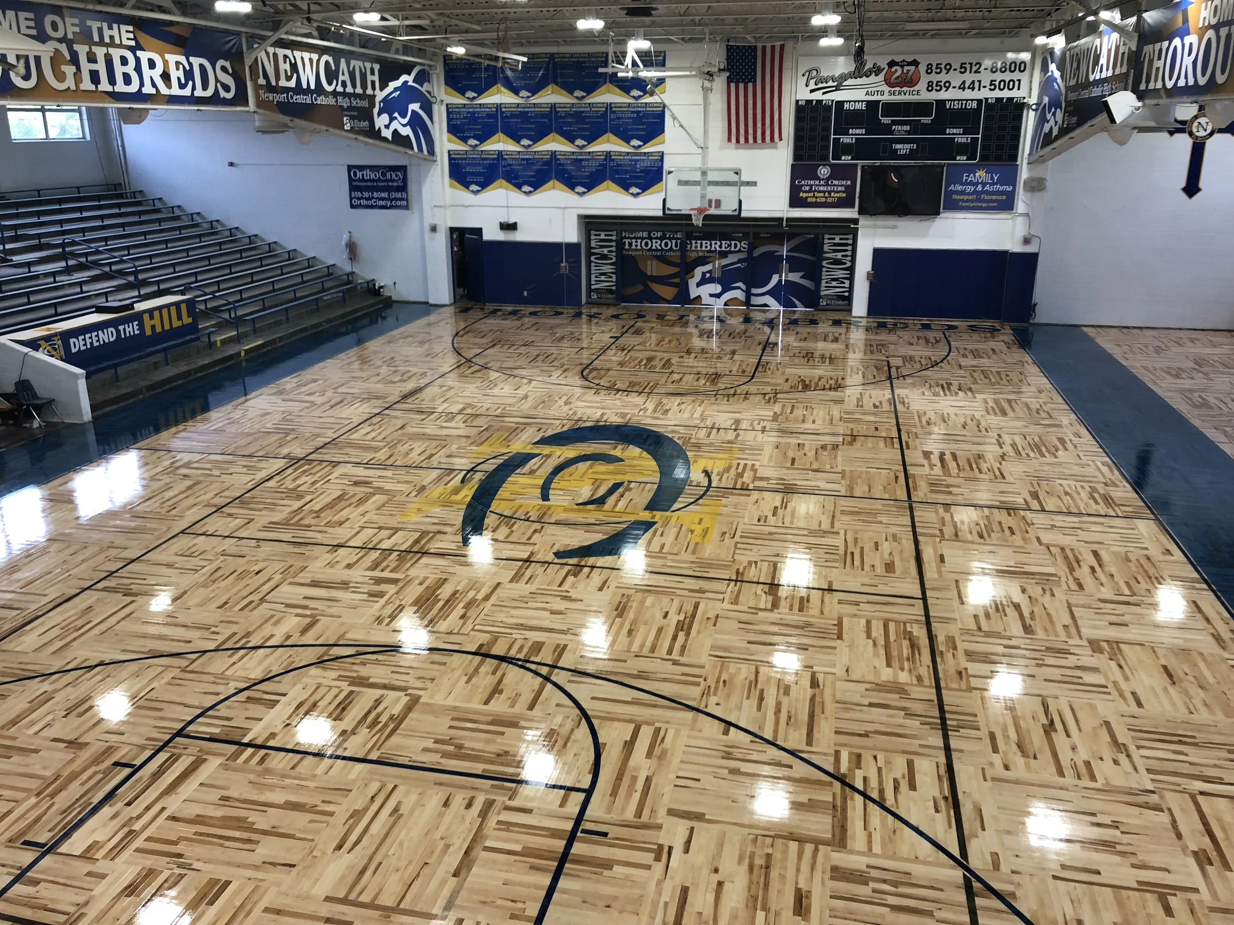 The new surface was installed this summer in a "Boston Square" pattern to tribute Cowens. It replaces the original from 1954 when the school was first constructed. The surface is not only used for sporting events like volleyball and basketball, but also plays host to our spring musical, major fundraisers, school assemblies, all school masses, guest speaking engagements and so much more. 