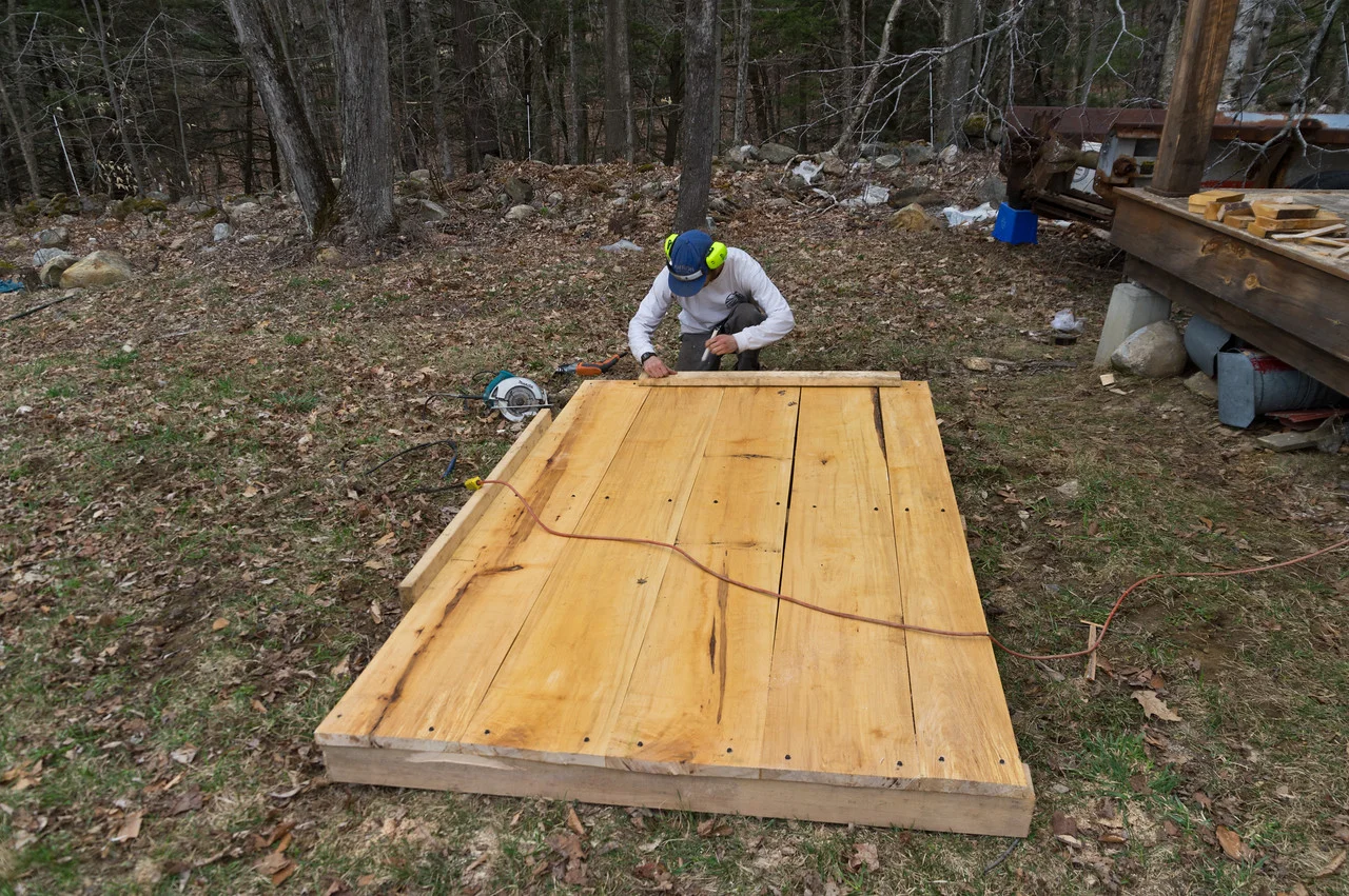 Peter building a new large pallet for the front of our tractor. We use a large platform like this to move around transplants and loaded harvest bins. After a couple years the pallet needs to be rebuilt. Thanks Peter! Photo by Adam Ford