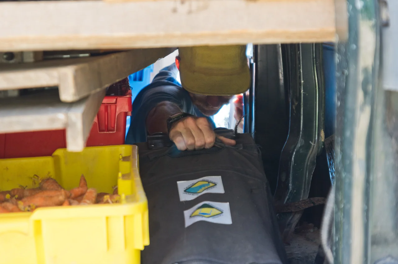 I love this photo of Peter packing one of the tents into the van before market... I feel like packing our market van is a higher stakes game of tetris, photo by Adam Ford.