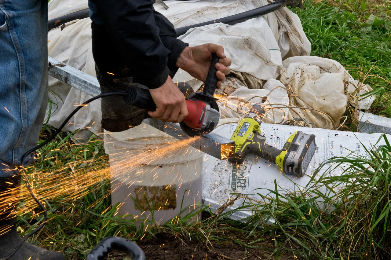 Cindy being the boss that she is, cutting the metal studs for the end walls on the new tunnel, photo by Adam Ford