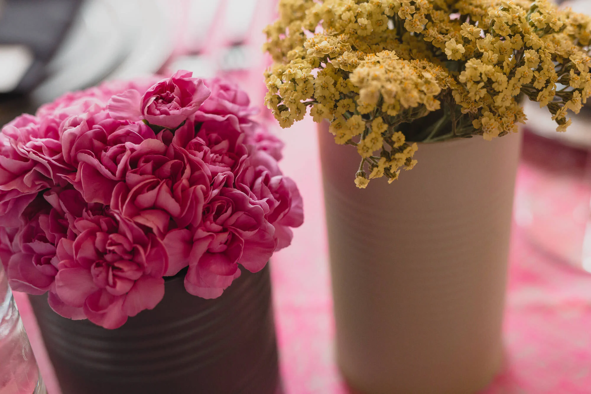  pink and yellow flowers in painted tin can vases 