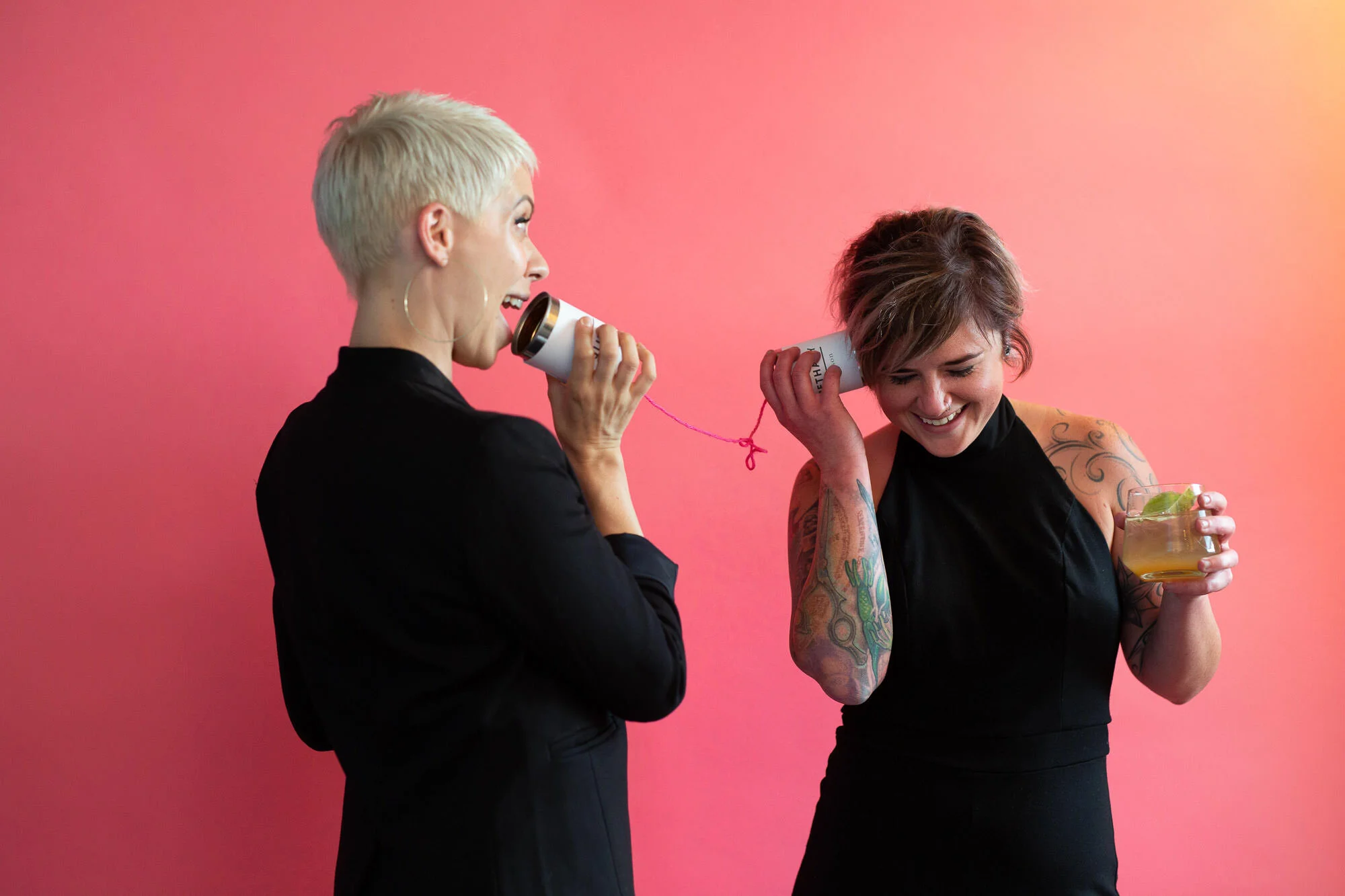  womxn talk on tin can telephone 