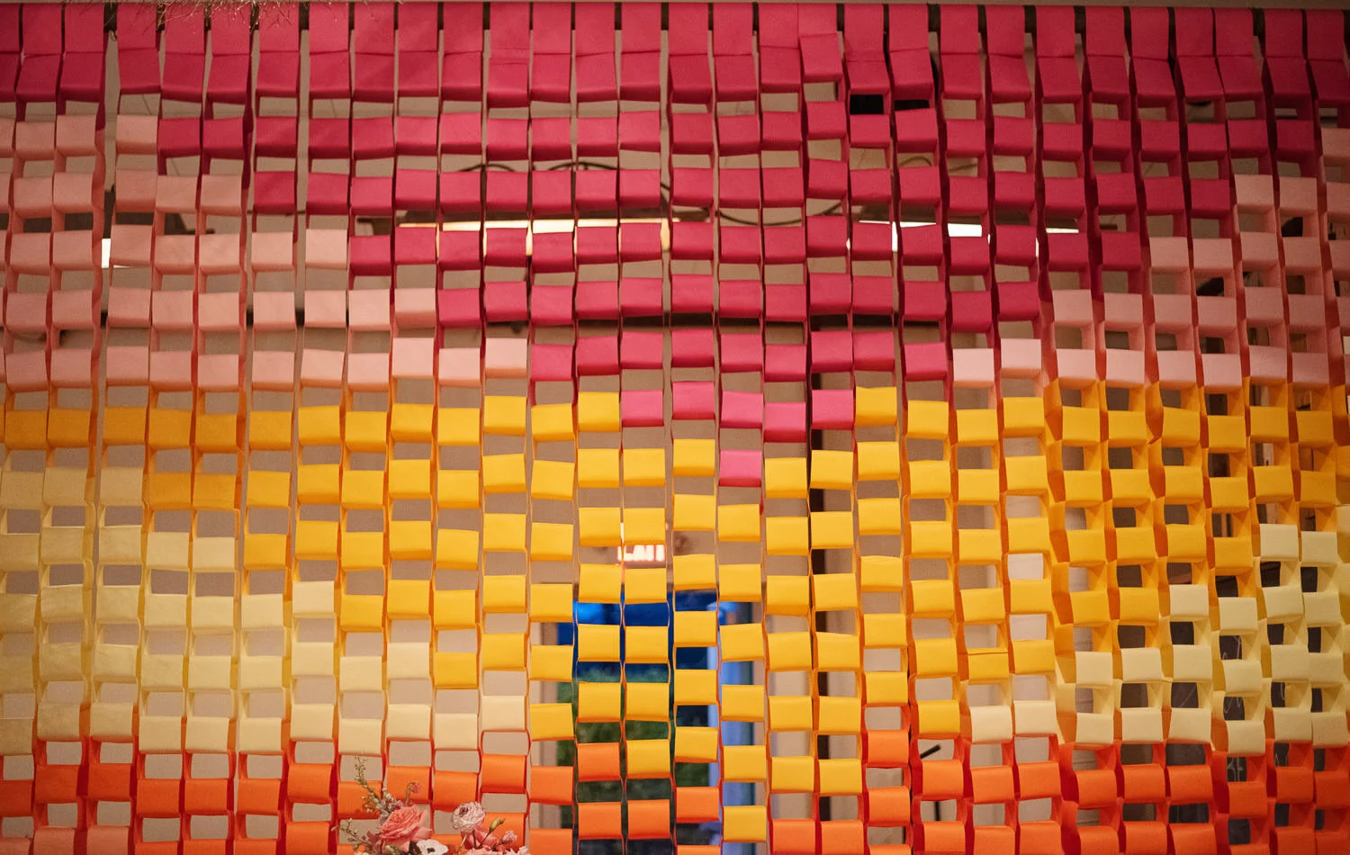  colorful red, pink, yellow, and orange paper chain installation 