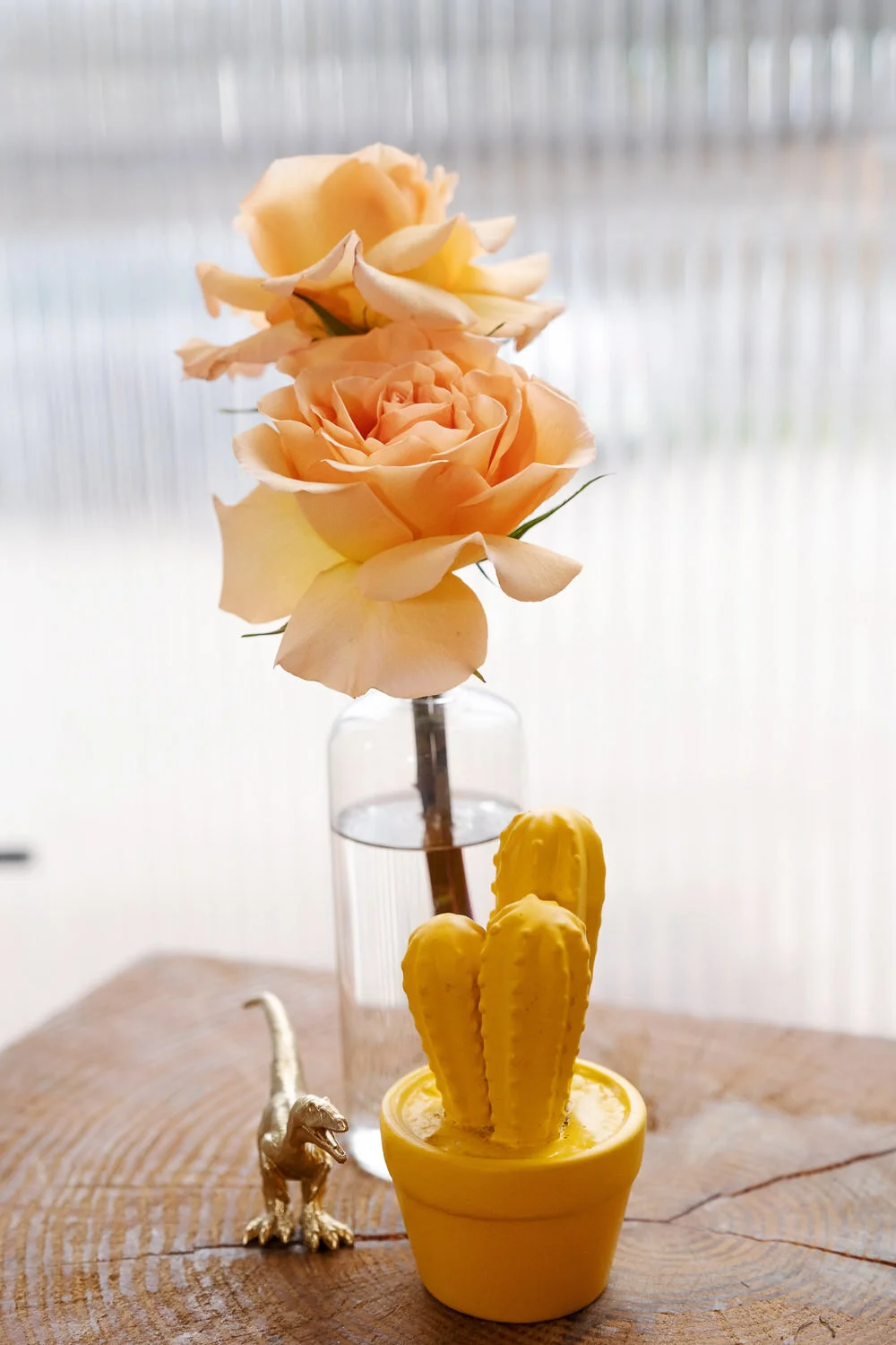  peach roses in water, yellow cactus and gold t-rex 