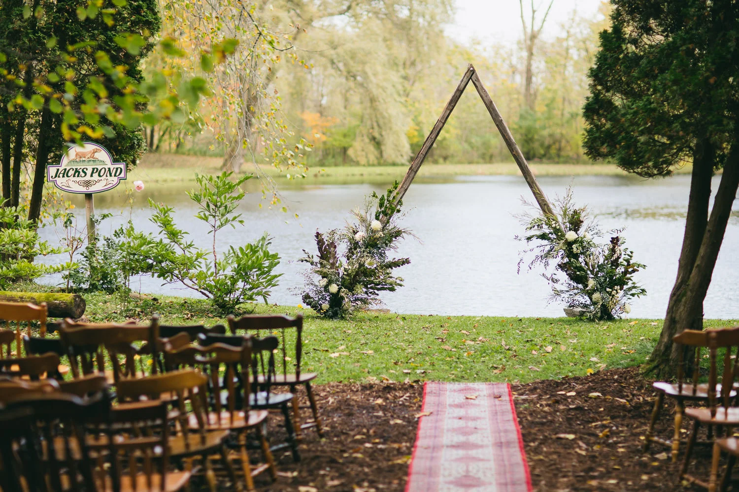  wedding ceremony site by pond with triangle wedding altar  