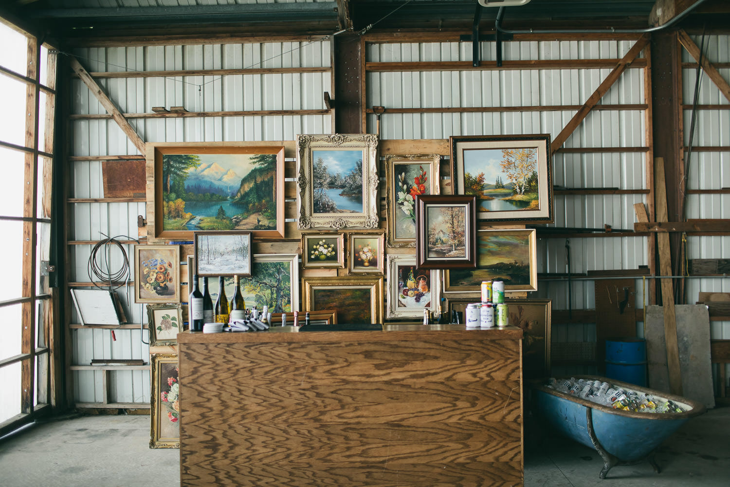  bar setup in airplane hangar with old paintings behind 