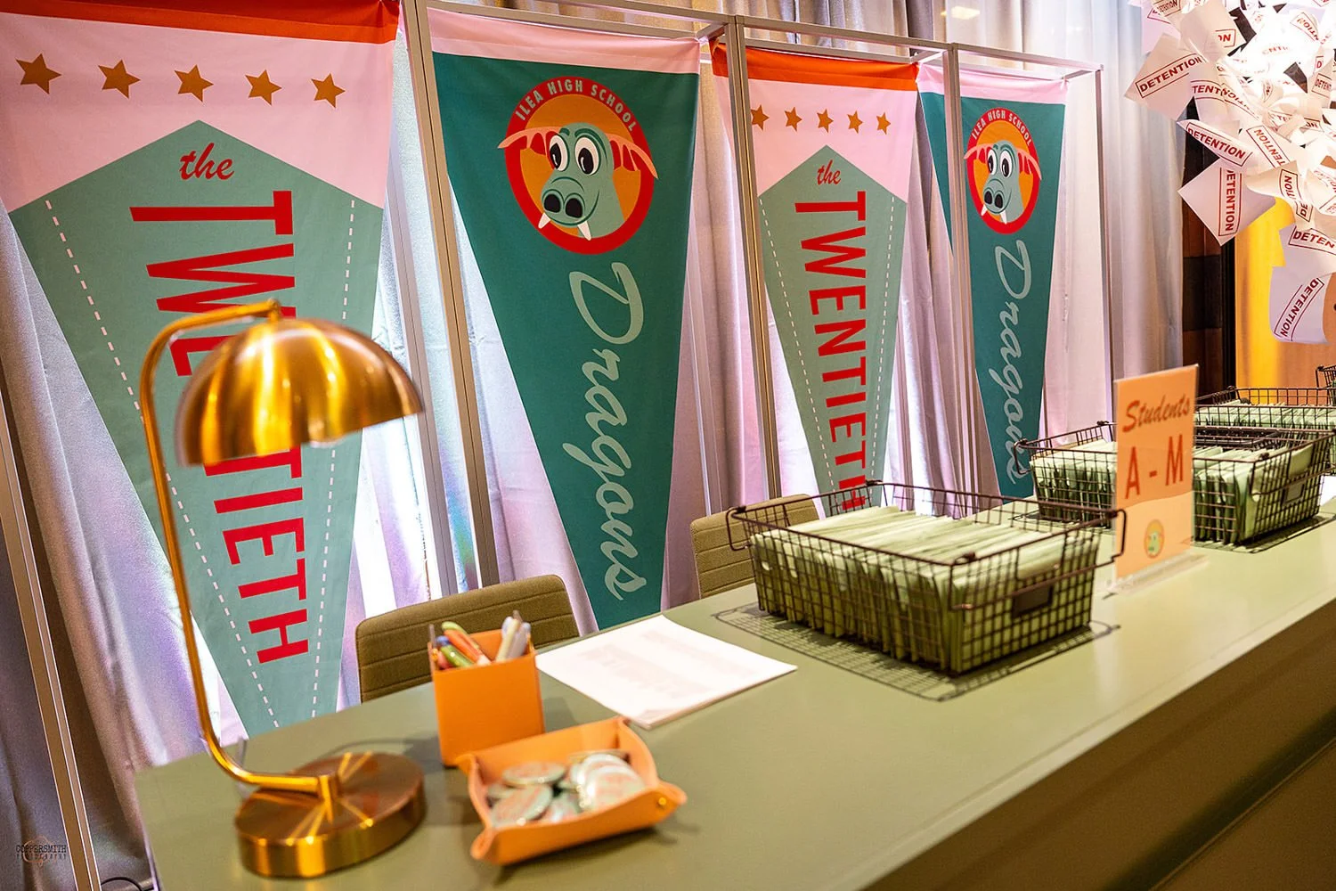 Class registration theme check-in area with colorful high school pennants.High School themed party design, ILEA Minnesota Star Awards, Designed by Rocket Science Events.