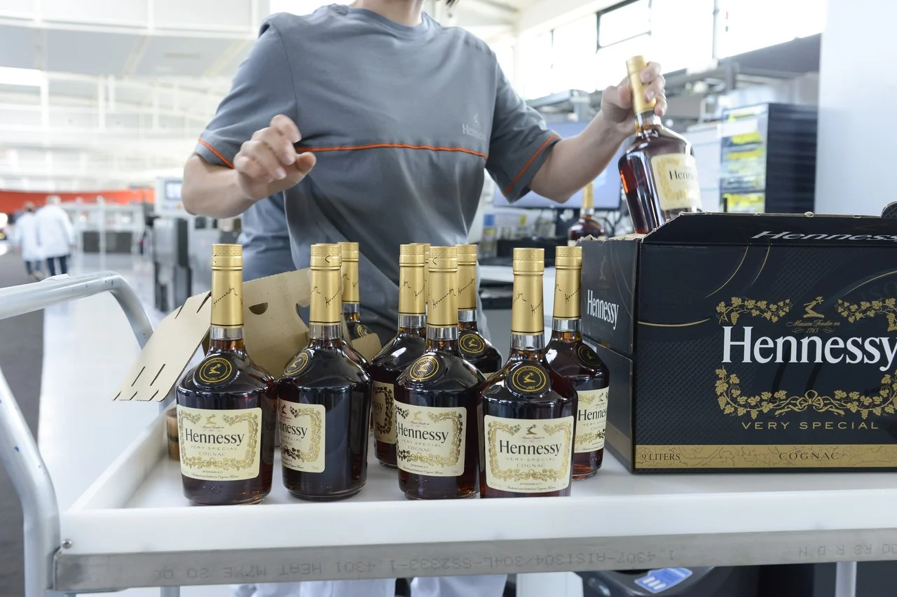  Bottles pass through a series of machines where they are filled with cognac, labeled and then packaged in twelve-bottle boxes.  JULIEN FERNANDEZ FOR THE WALL STREET JOURNAL 
