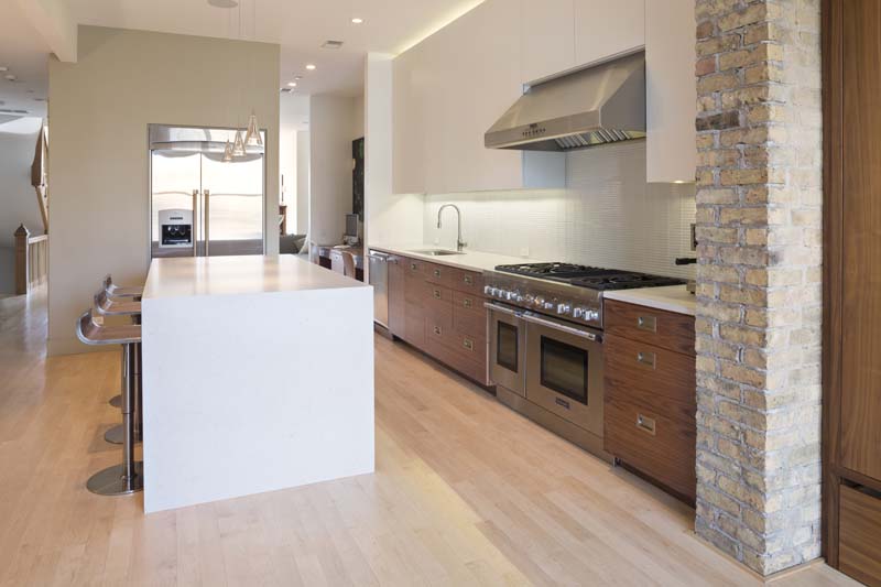 Potomac Kitchen Flat cut walnut kitchen cabinetry, natural lacquer finish. Upper cabinets in a dull lacquer.