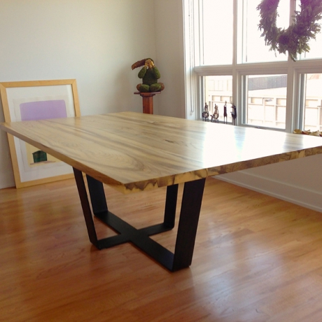 Reclaimed Hackberry Dining Table Hackberry lumber top with natural lacquer finish and black patinated steel base.