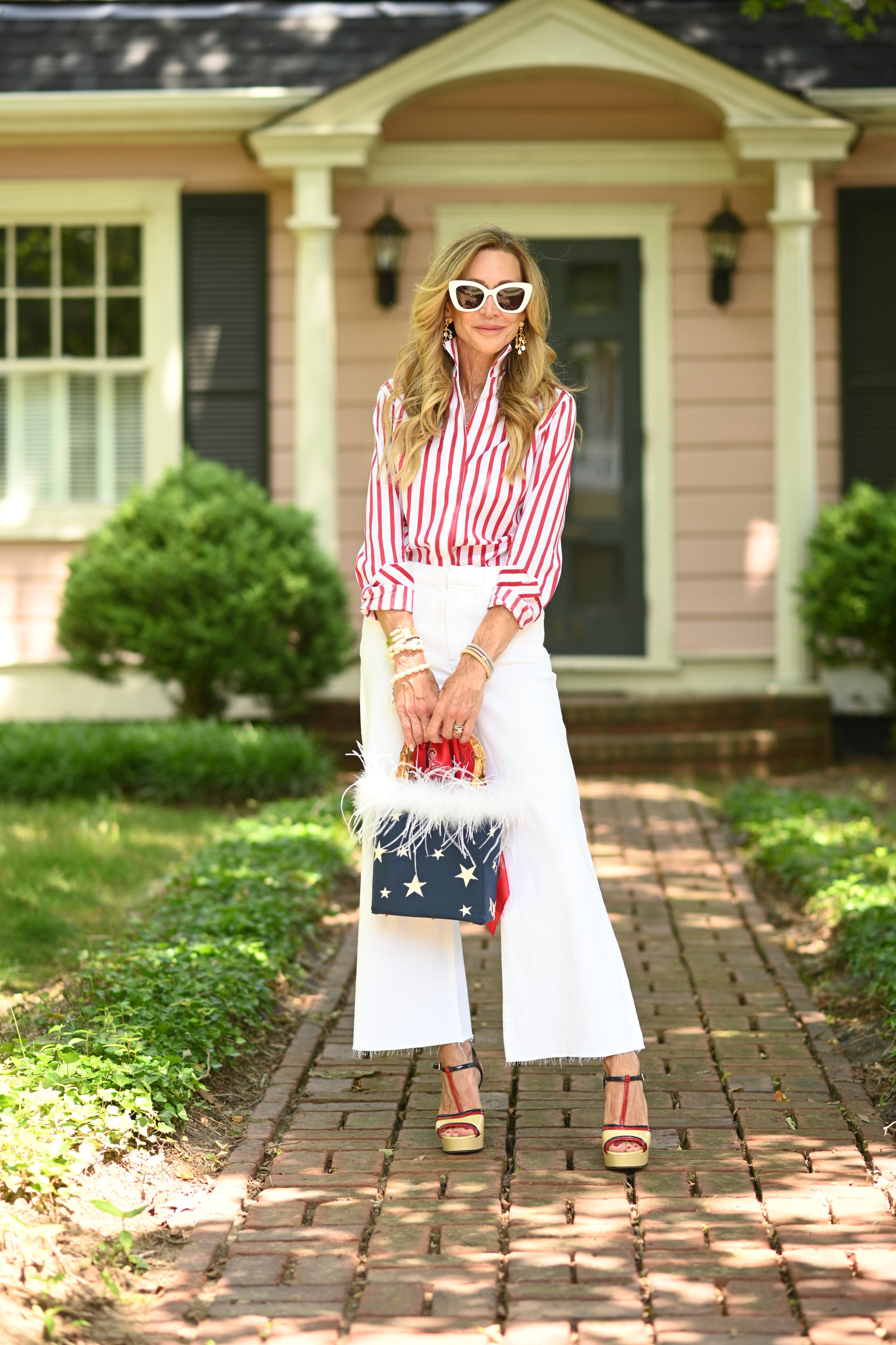   A feather bag from     Coastal Clutch New York     is the icing on the cake for this layered look!  I added a bandana to the bag for a little something extra.  My Gucci sandals are at least 10 years old and I still love them!  I do not let go of my older designer pieces (or anything I love)…I wear them!  My blouse is from     Sarah Alexandra    , my pants are from     Frank & Eileen    .  