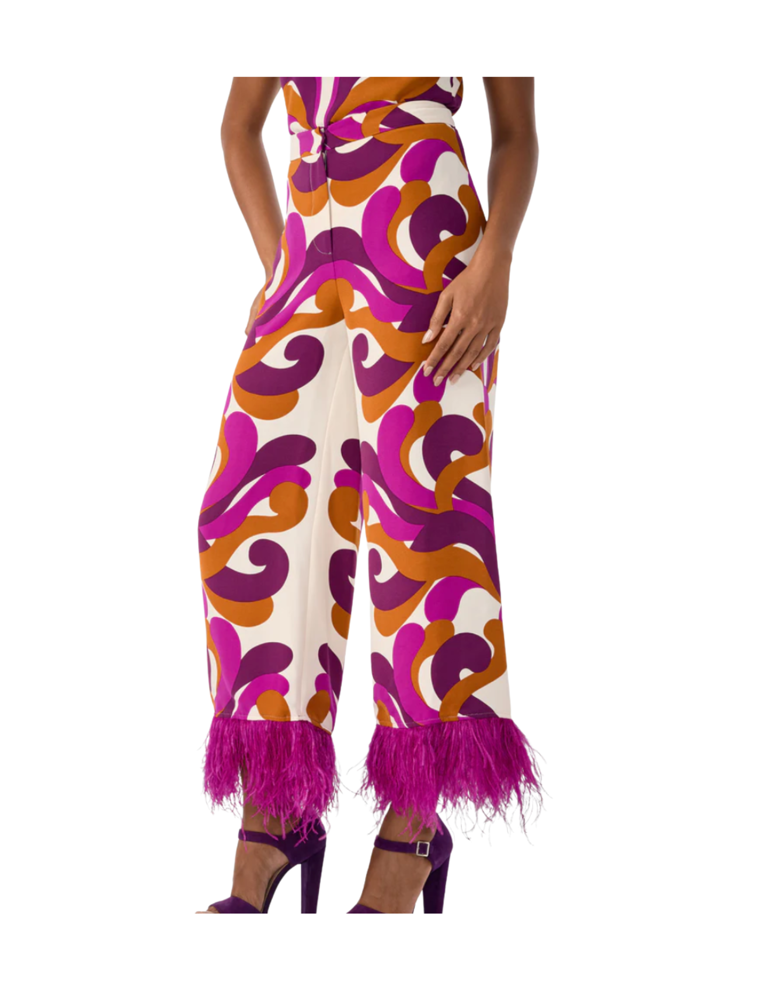 Fashion model wearing wide-legged pants with bold, colorful pattern, pink feather details at the cuffs, and purple high heels.