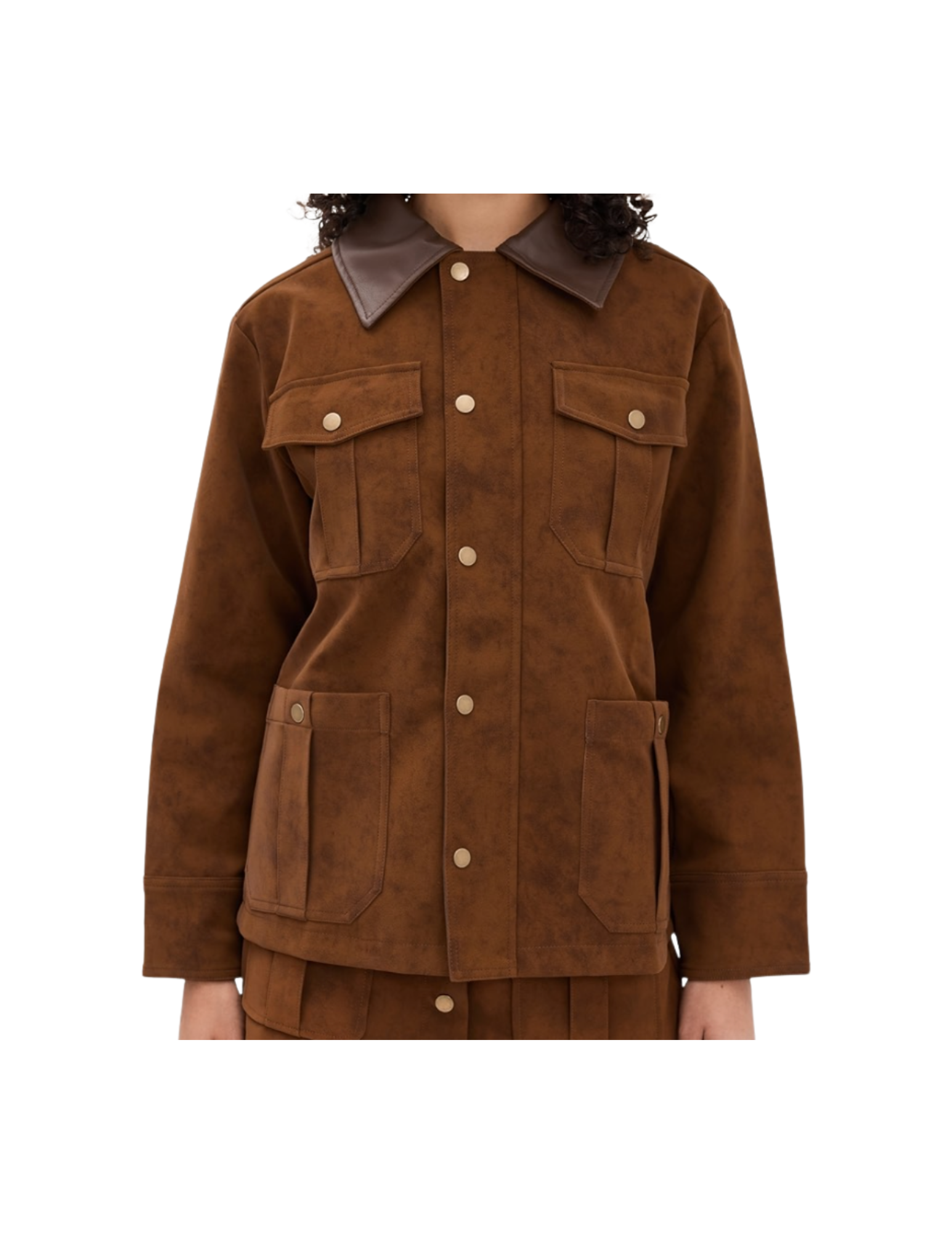 A woman wearing a brown suede jacket with large front pockets and a darker leather collar.