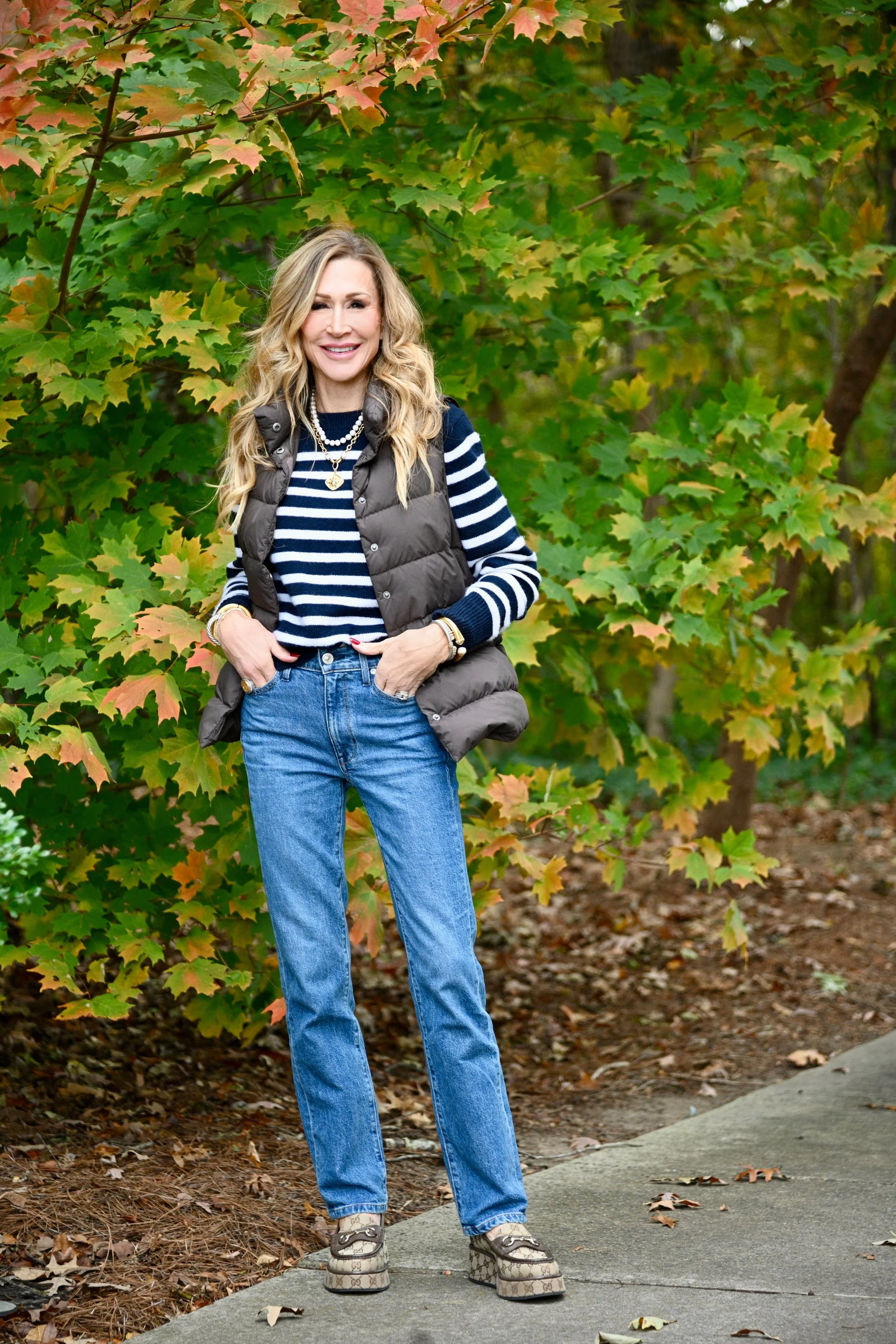   Brown Loafers,    Medium Wash Jeans   ,    Puffer Vest   ,    Striped Sweater   