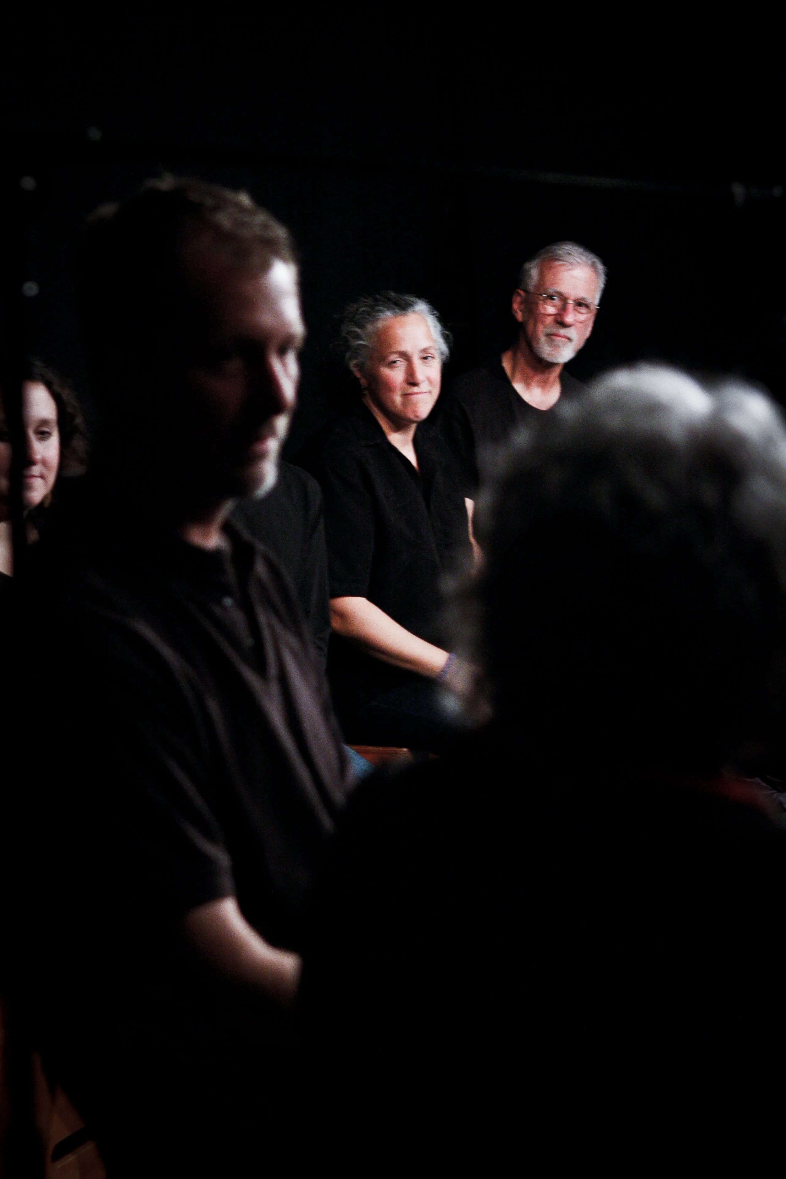 The cast listens as an audience member shares his story
