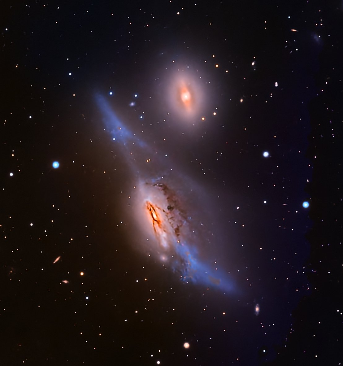 NGC 4438 is one of the most violently disrupted galaxies in the nearby universe, located about 50–55 million light-years away in the Virgo Cluster. Once likely a normal spiral, it now appears heavily warped, with torn dust lanes, asymmetric stellar s