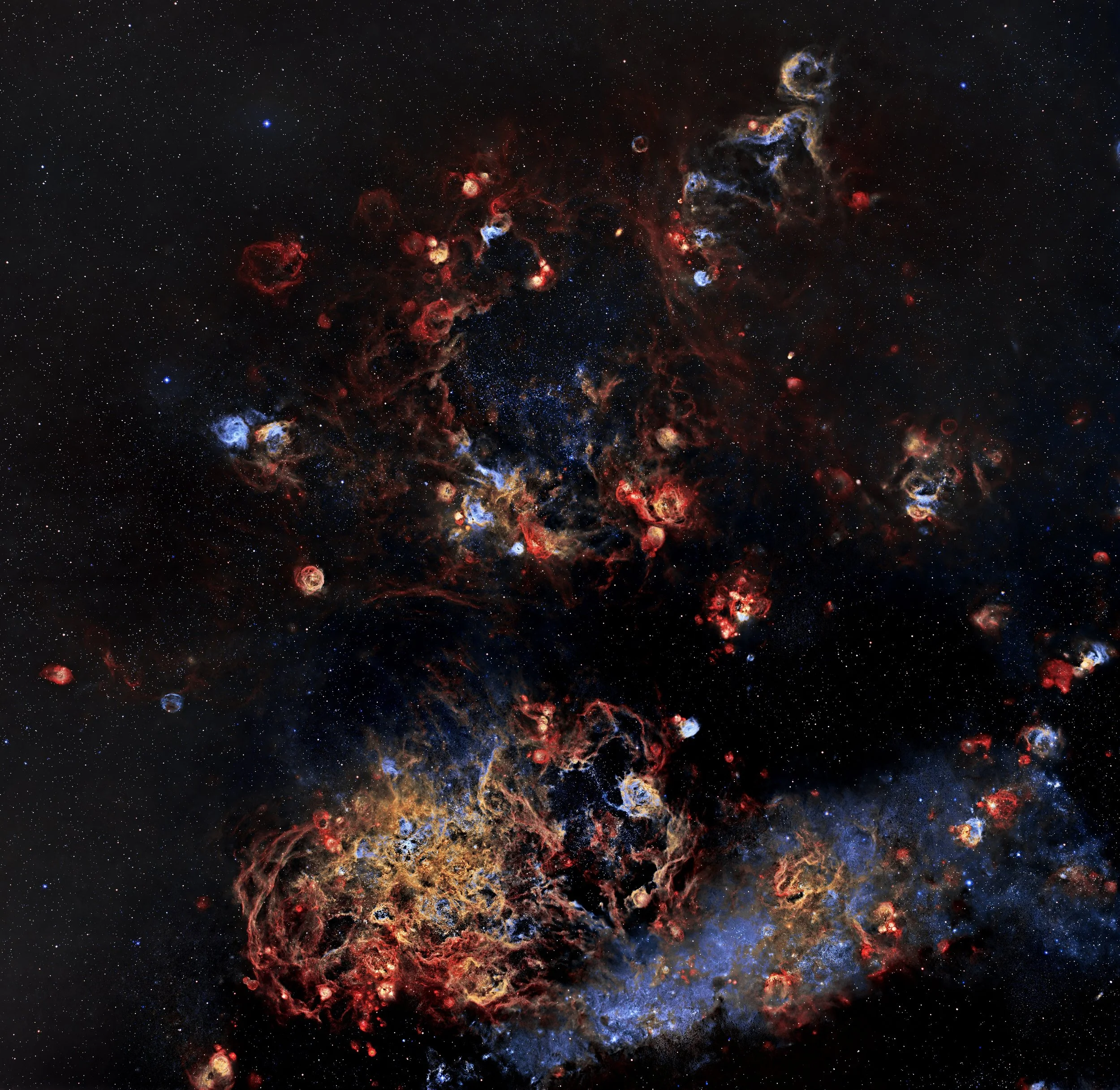 NGC 2014 is a bright star-forming nebula in the Large Magellanic Cloud, about 160,000 light-years from Earth. It’s dominated by hot, massive O- and B-type stars whose intense ultraviolet radiation causes the surrounding hydrogen gas to glow. Visually