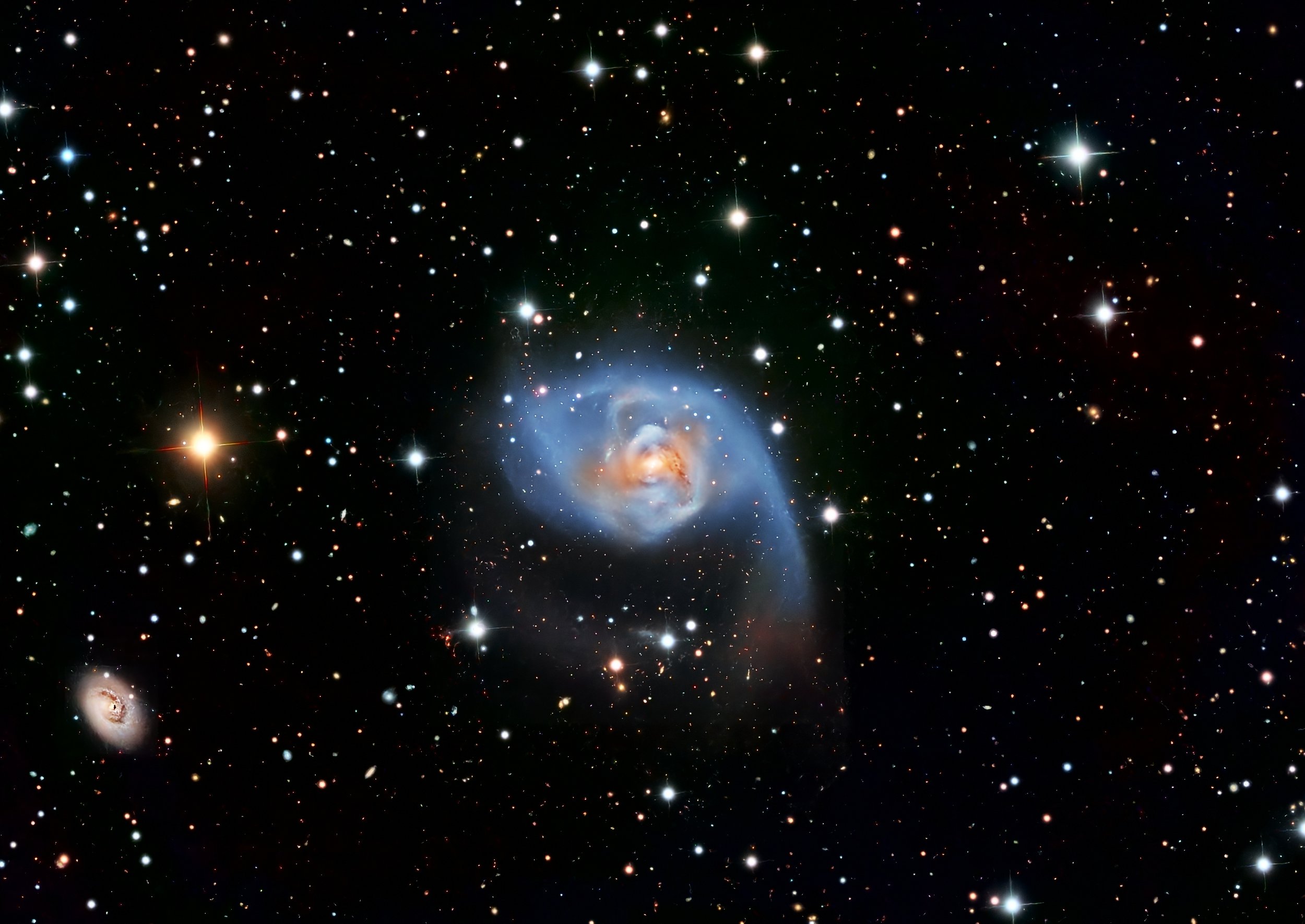 NGC 7727 is a nearby peculiar lenticular/elliptical galaxy about 90 million light-years away in the constellation Aquarius, and it is widely regarded as a late-stage galaxy merger remnant. 

At first glance it looks relatively smooth, but deeper imag