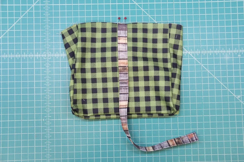 Pin first end of wrist loop in place