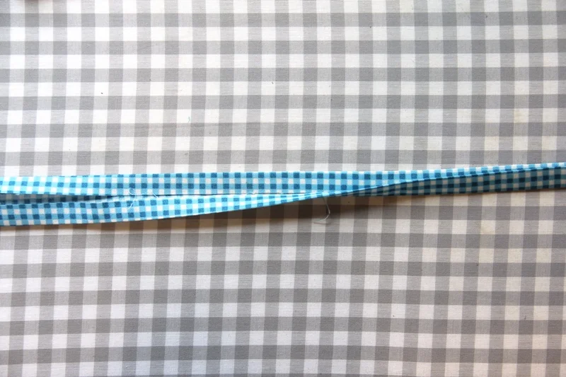 Folding tie strips in half