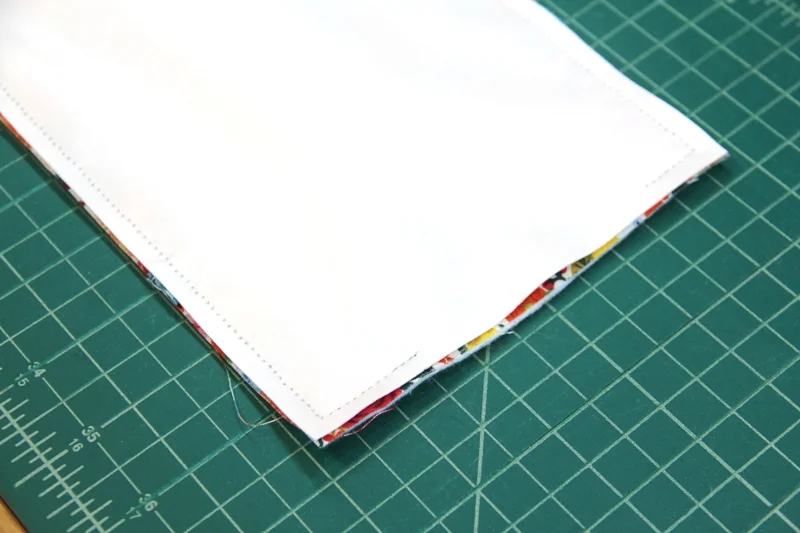Stitching fabric to poly laminate