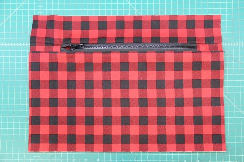 Press top and bottom away from zipper