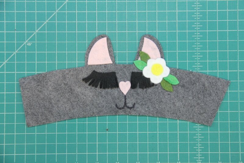 Mouth drawn onto llama coffee cozy