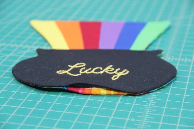 Press and turn in opening on End of the Rainbow Mug Mat