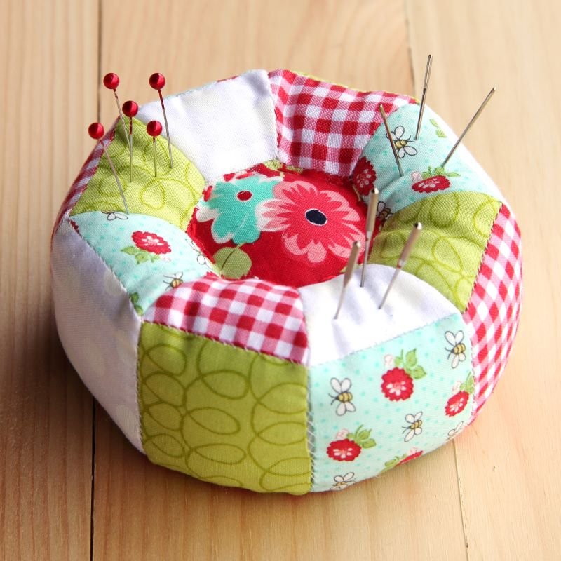 Octagonal pincushion with pins and needles.JPG