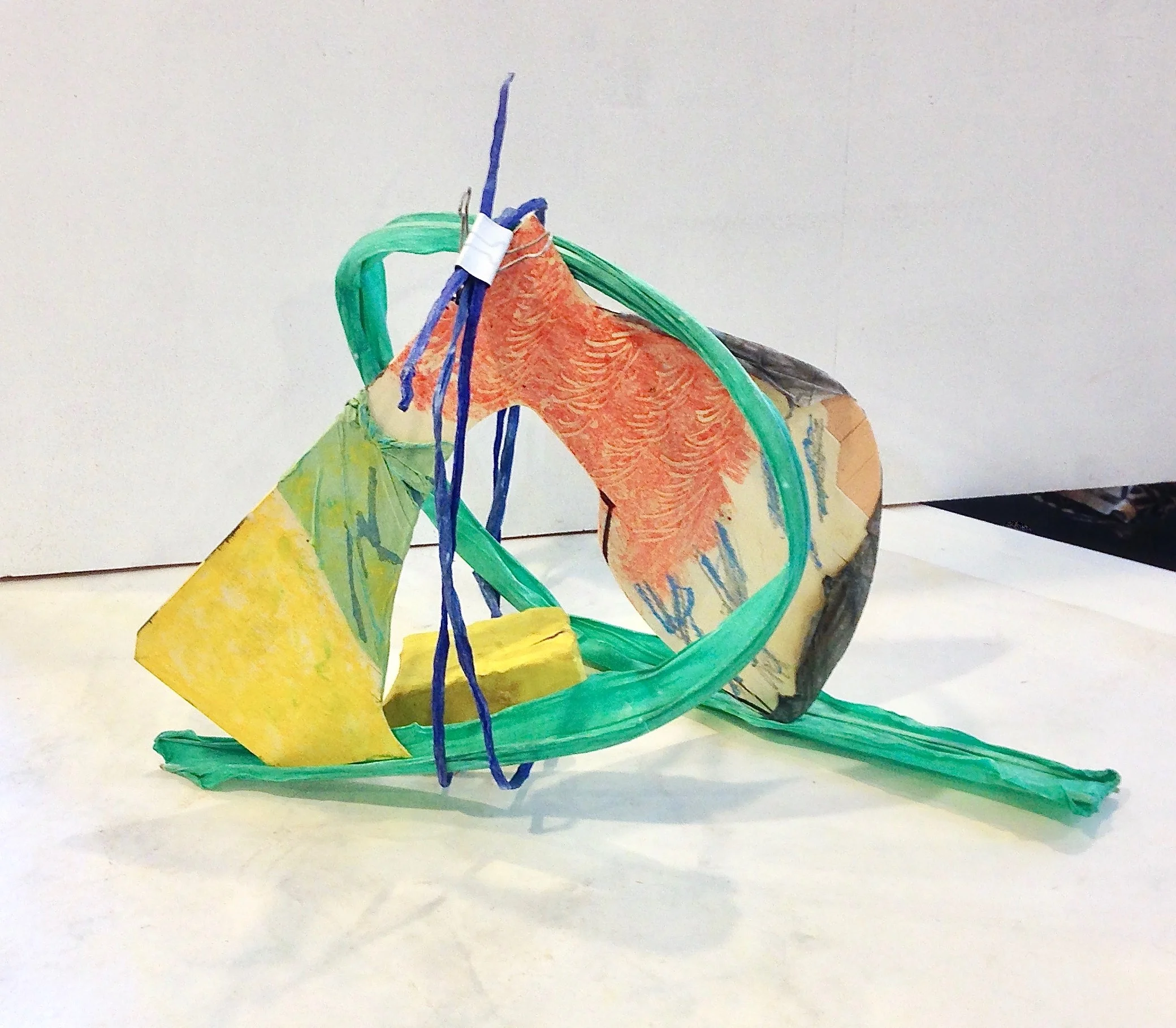 Inspiration under my feet and over my head 2018 abaca and cotton papers, plywood with papers, pastel and paste paper application, bamboo, yellow abaca’d rock, bull clip (optional) 18” x 30” x 14”