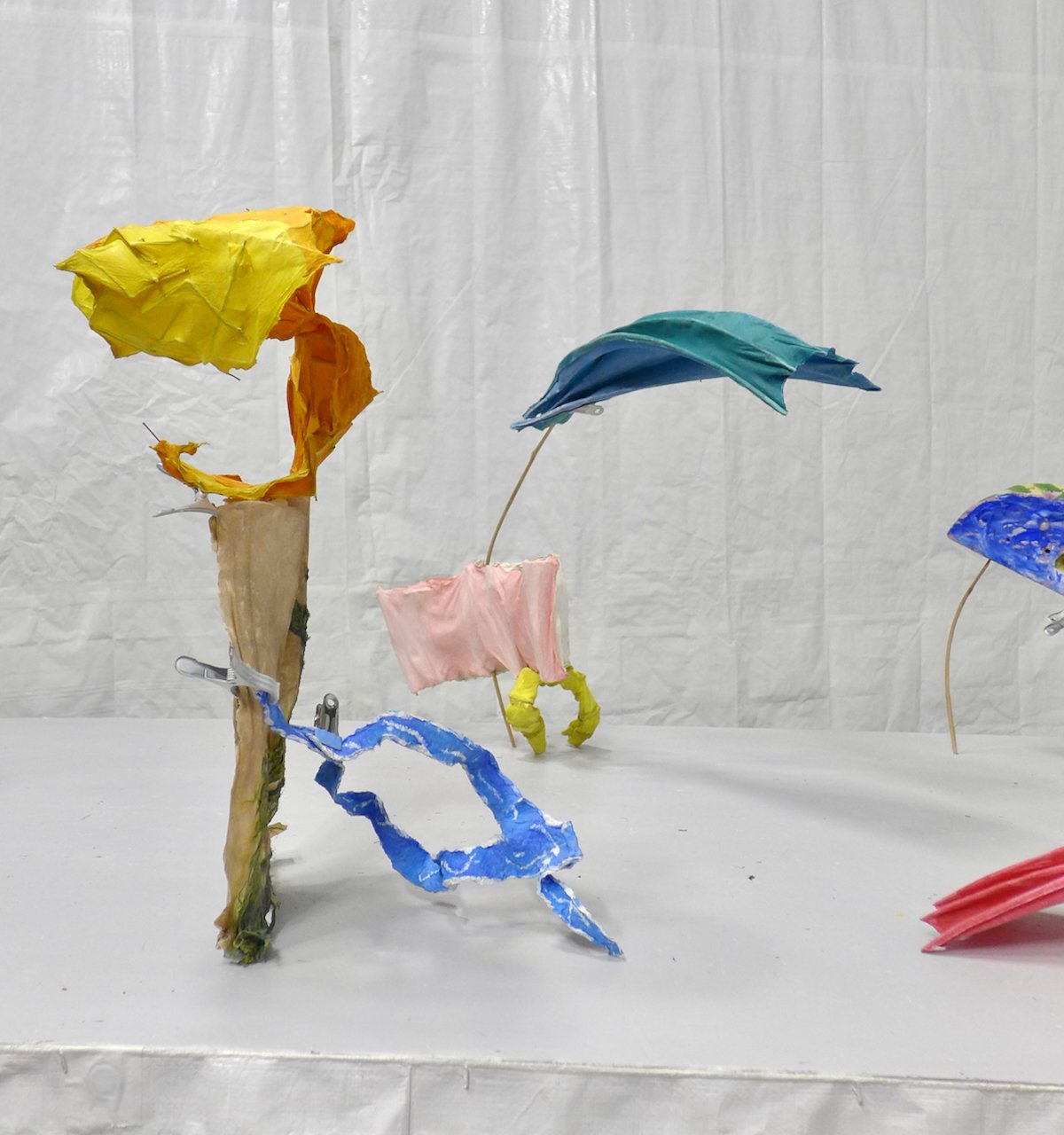 colorful objects composed and collaged together and grouped on a tabletop