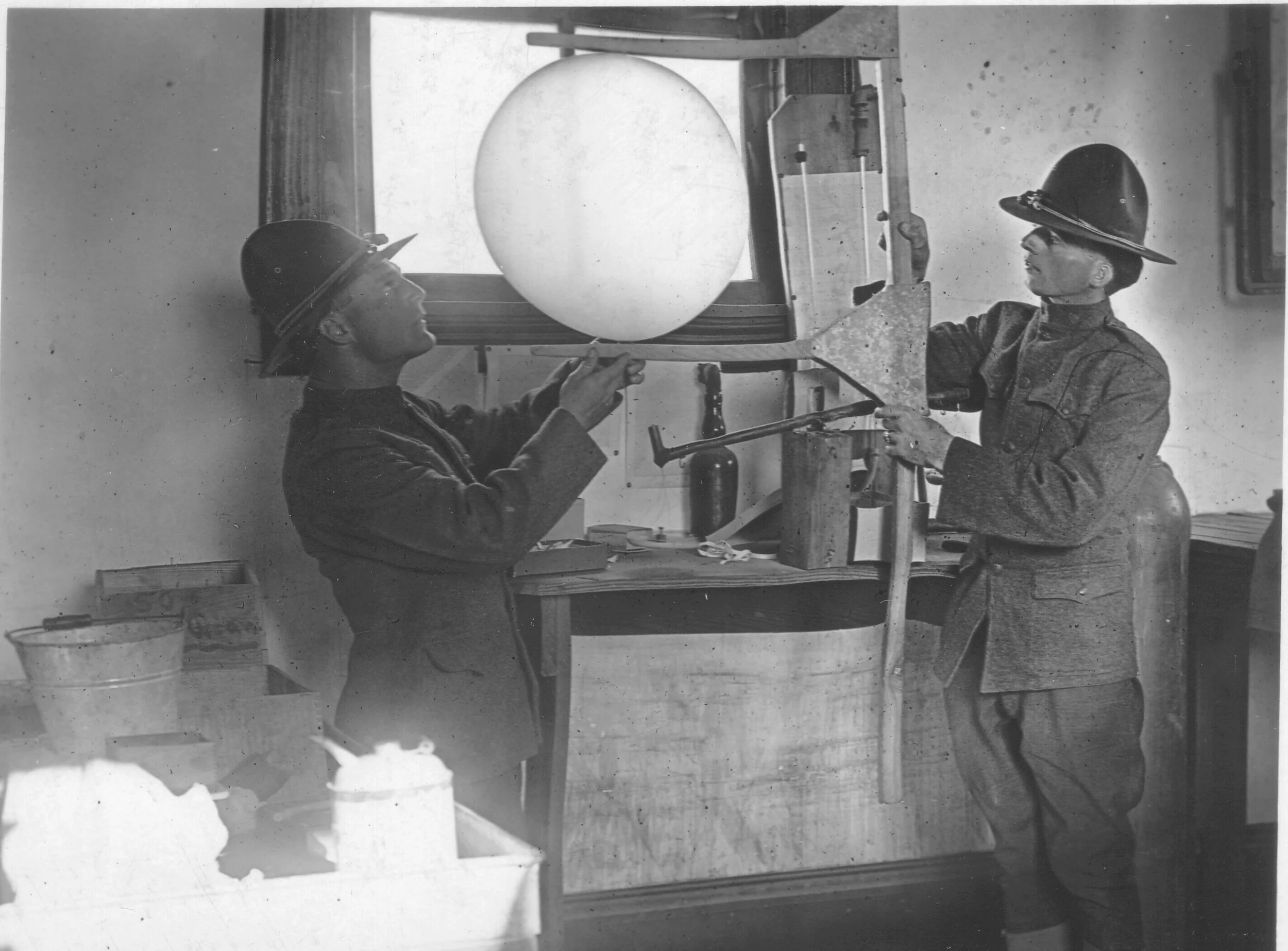 Privates Bly and Greening measure a weather balloon to ensure it is properly filled with hydrogen. Photo by A.W. Atkinson, US Army Signal Corps. Courtesy of the US Army Heritage and Education Center, Carlisle, PA.