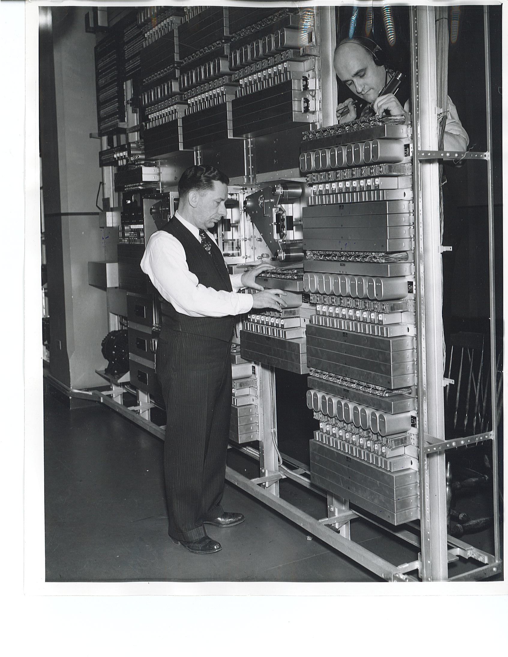 Maintenance men work on the automated recording and reproducing apparatus that communicated weather forecasts to tens of thousands of Detroit telephone users in 1940.