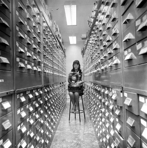 “A girl holding a decade of Australian weather records in her hand on a modern-type magnetic disc storage unit,” 1970. Produced by the Australian News and Information Bureau, via the National Archives of Australia .