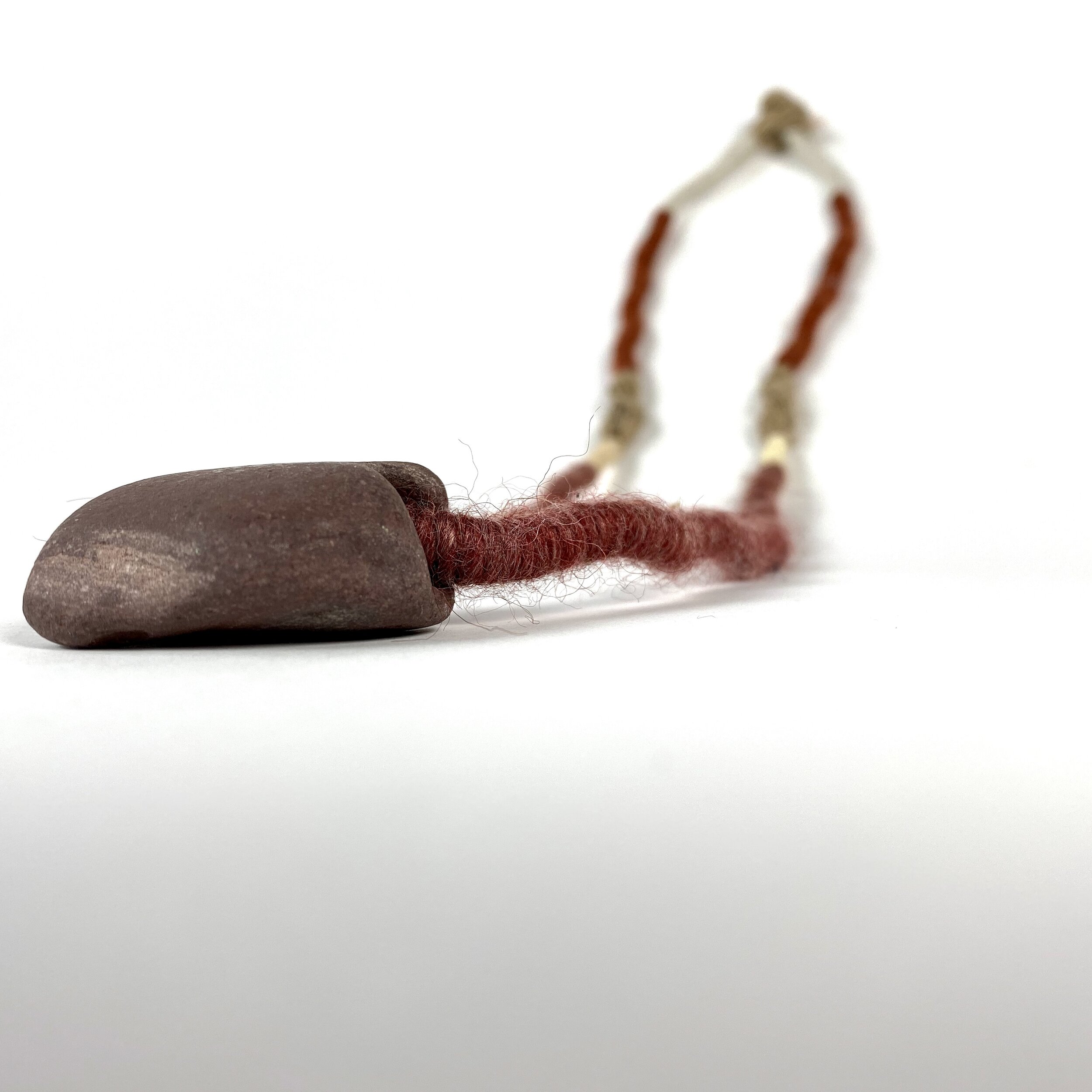  Untitled “Coiled Neckpiece”.    Found stone &amp; yarn.   2019 