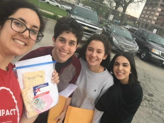 Alex Boutros (left) stands with volunteers from Chicago Lawyers' Committee and DePaul Students Against Incarceration outside Cook County Jail after registering voters in pre-trial detention.