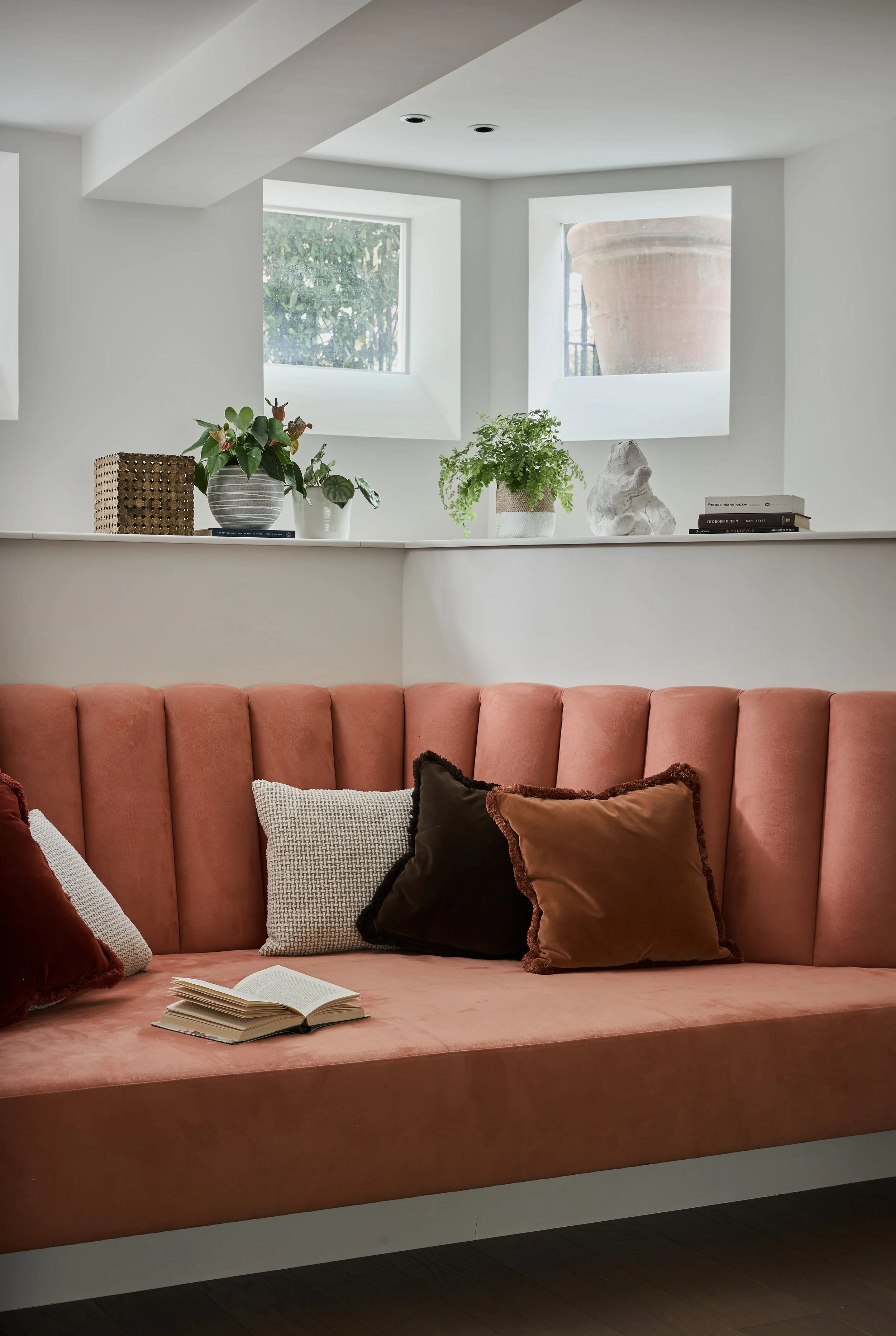 This dusky pink velvet seating area known by our clients' daughter as 'the mermaid chair' was designed to fit an existing bay within the basement space. Designed for reclining and reading this has fast become a beloved space.