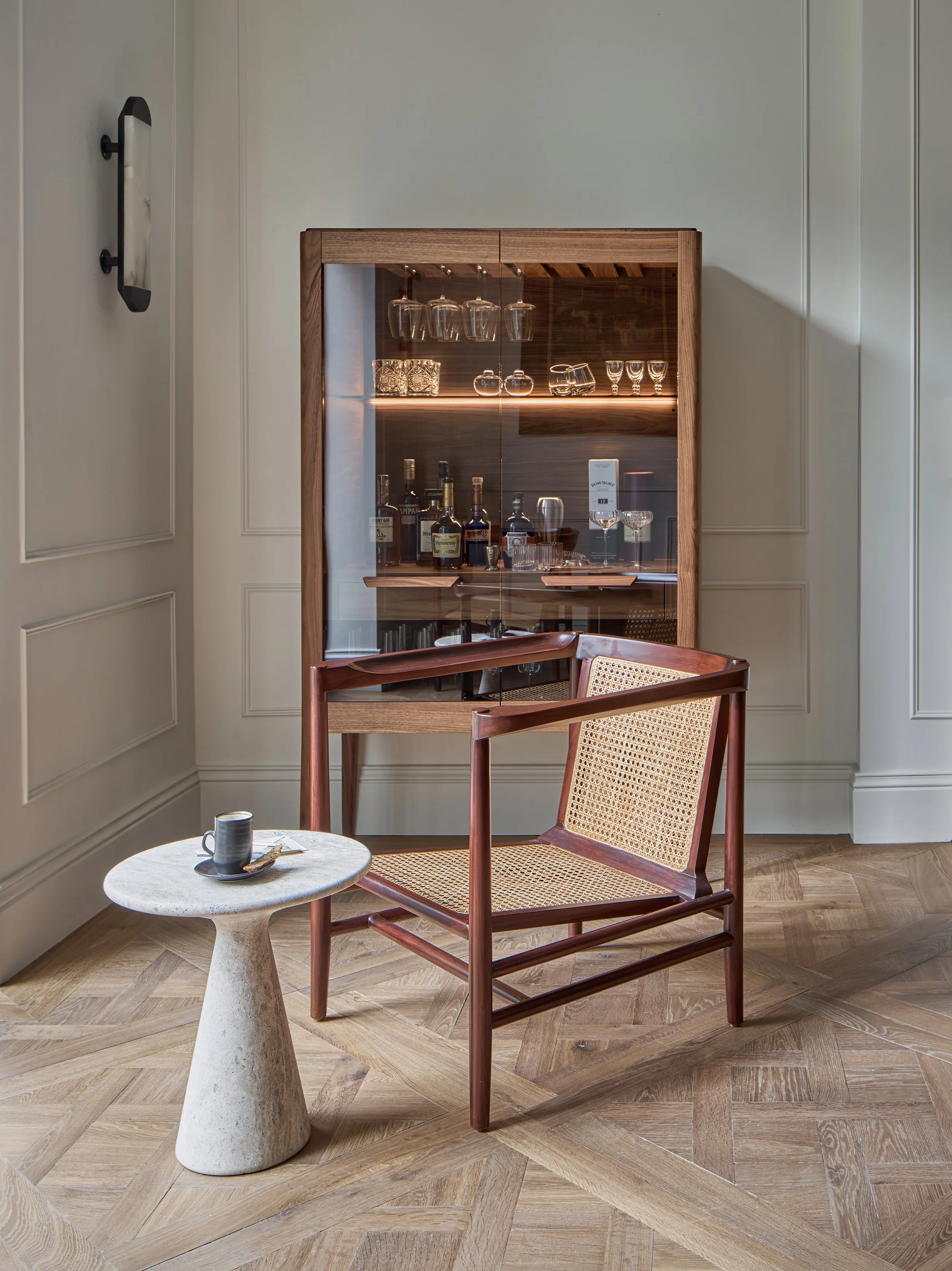 The relaxing bar area includes chairs by Tenriero, marble side table by Ransom and Dunn and a stunning Walnut bar by Porada