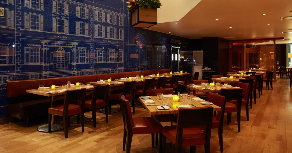 Blue bring wall art and long booth in dining room