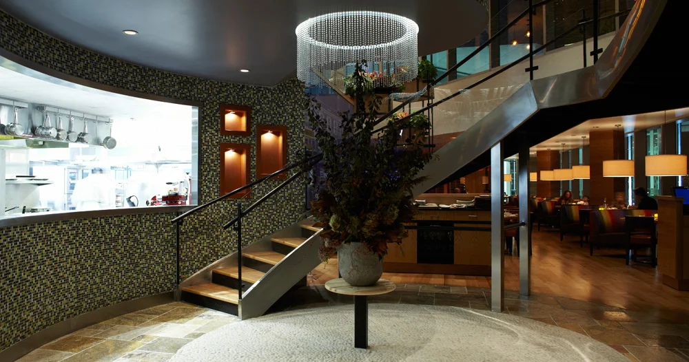 Metal stairway with chandelier in round entryway