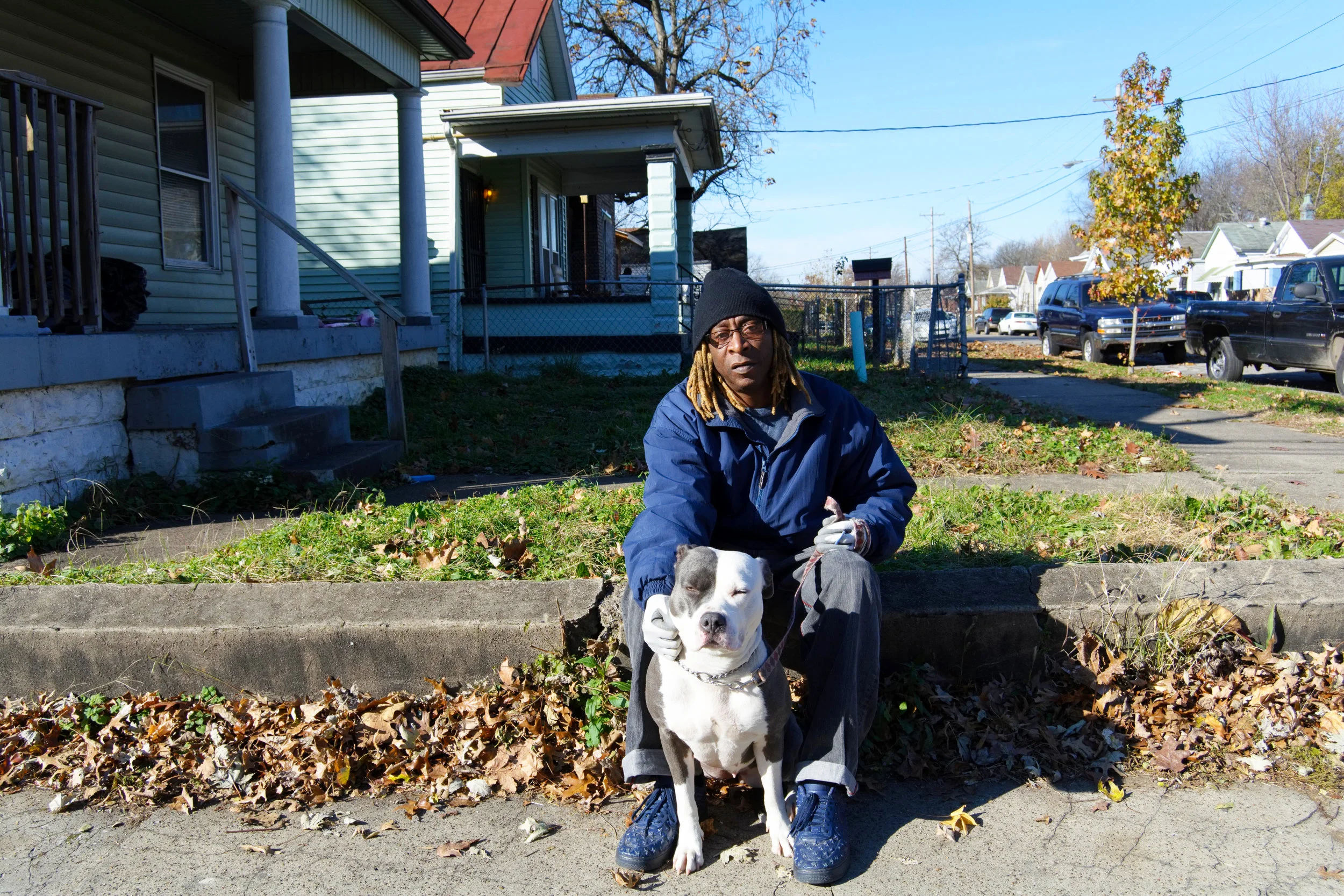 "I'ma keep it real with you. I just got back into God. I got three girls. Out of my three girls, my oldest one is still living. When I was living in Baltimore, one of my girls was 7 years old and got shot in the head. I came back to Louisville and my 16-year-old got shot in the head. My 40-year-old came back from Alaska and now she lives in Houston. I got four grandkids. I turned 60 on Friday and for a long time, I had doubts about God. You know, I lost my two girls, my father died in my arms and came back to Louisville and my grandmother died. I finally got to meet my mother, whom I didn't know for 25 years. I couldn't say that I loved her or liked her, and she died. I also had a sister that jumped off the bridge, so I had a lot of tragedy. I'ma keep it real with you. I was diagnosed with depression and suicidal, I get SSI. I had three suicide attempts, but for some reason, he's holding me here. I'm just keeping it real with you, it's my life story. Now, 12 years clean and sober, I don't do anything but walk this girl (points to the dog), that ain't mine. I stay with my sister, who is 20 years clean and sober. On April 7th, next year, I'll be 13 years clean and sober. I had a messed up life. Now, I'm getting God back into my life. I still have questions and doubts, but that's understandable, with everything that I've been through. For me, staying with my sister and my aunt helps me. I ain't been going to church every Sunday, but I go. As far as knowing the Bible, I don't know it but I'm getting to it. I'm dyslexic, but I'm teaching myself to get through it. My oldest daughter came back to life and that motivates me. I abandoned her, in the past. When I graduated from Drug Court, she was the only one that was there for me. She came all the way from Alaska for my graduation. As long as I talk to her once a week, I'm good. I don't associate with too many people. I walk her. She's a good therapy dog. She's not mean to anybody. This is my buddy. Be patient, things will change. I didn't think that it would. I had a gun to my head, rope around my neck and I had drunk some shit. He pulled me through all of it. When I knew that all the windows and doors were locked and I had a .45 to my head and somehow my cousin got in and knocked the gun out of my hand before I pulled the trigger. After my daughter was killed, I tied an extension cord around my neck and hung myself, but someone came in and cut the cord. I was really depressed. You gotta be patient and have hope. I've been patient and I have hope. I can handle anything, now. The difference between a good day and a bad day is your attitude. Keep it moving." - Sam, Parkland