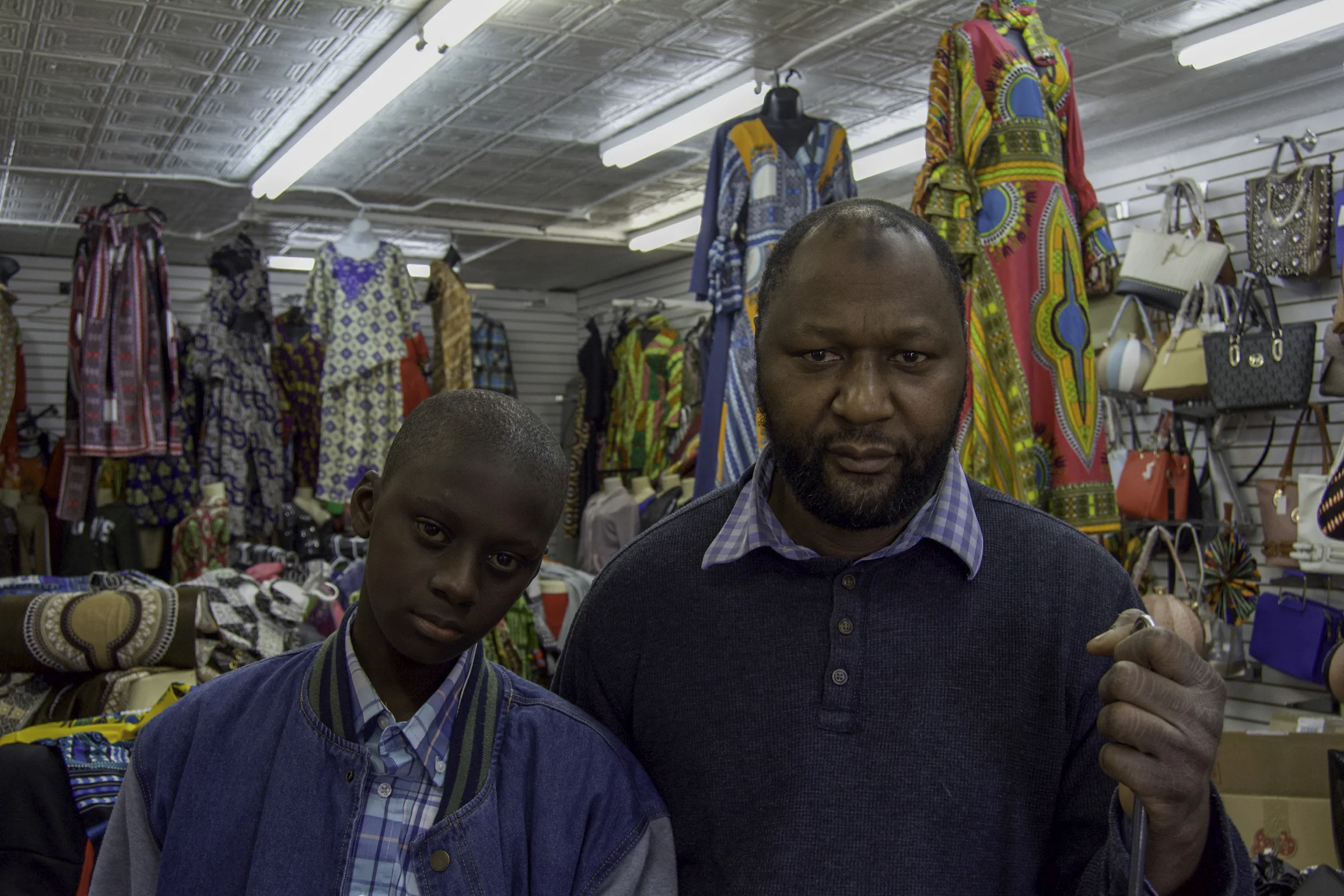 “I’ve been here since 1998. It’s been twenty-one years. When I came here, I was the only business here. It was just me, Chevron and Kroger. I remember when I first opened up my business, the police used to be worried about me. At that time, there was a lot of crime over here. If I had a problem with the building and needed repairs, people would ask for my address and I would tell them 2015 West Broadway and they would tell me that they didn’t come this far. That was just twenty years ago, not even a long time ago. People were scared to come to the West End. Now, people are coming back to live here and the crime is lower. People are wanting to spend money and support black businesses. I think that if they do that, it’ll help us and the community. We live here and we’ll spend money here. It’s a lot of changes. When I first came here, it was rough and there was a lot of crime and lot of stuff. Things have changed. None of these buildings were here. It was a lot of empty lots. So, it’s a lot of changes. I think with the new developments, they could do more. Even with the little things that they do, it would make some big changes. For example, they were supposed to put Walmart over here and people fought. Walmart would have been good. It could have brought a lot of people from a ten mile radius. With Passport, I don’t know. I hope they hire people from the West End. They said that they were gong to hire five hundred people. I hope it’s not going to be a bunch of people, from outside, that will just come to work and go home. We’re not going to benefit from it. The YMCA will be good for the neighborhood. The director said that he’s going to make sure that every kid knows how to swim, so that’s good. That’ll be a positive thing for the neighborhood. I think the West End is headed in a good direction, if they let us do more. We have to come together and do more instead of complaining. For example, they complained about Walmart. Now, Walmart’s gone and what do we get? We get nothing. Walmart being here, would have kept people from going so far. It would have been competition for Kroger and they would have to drop their prices. But they didn’t look at it that way. Also, they were going to hire two to three hundred people in the neighborhood. Also, people wouldn’t have to travel to ten miles. The closest one is where? Cane Run? Indiana? Instead people complained about a parking lot. Would you rather park five hundred feet or drive ten miles? It just doesn't make any sense. We gotta stop the complaining.” - Babinta Kiota, owner of Broadway Fashion & Decor , pictured with Mohamed, Russell