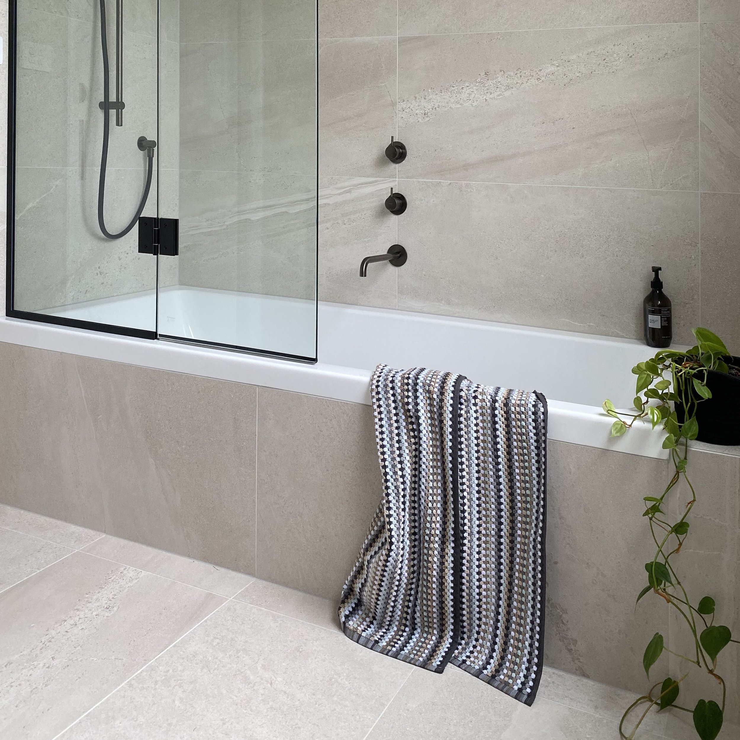 Tiled in bath with shower over