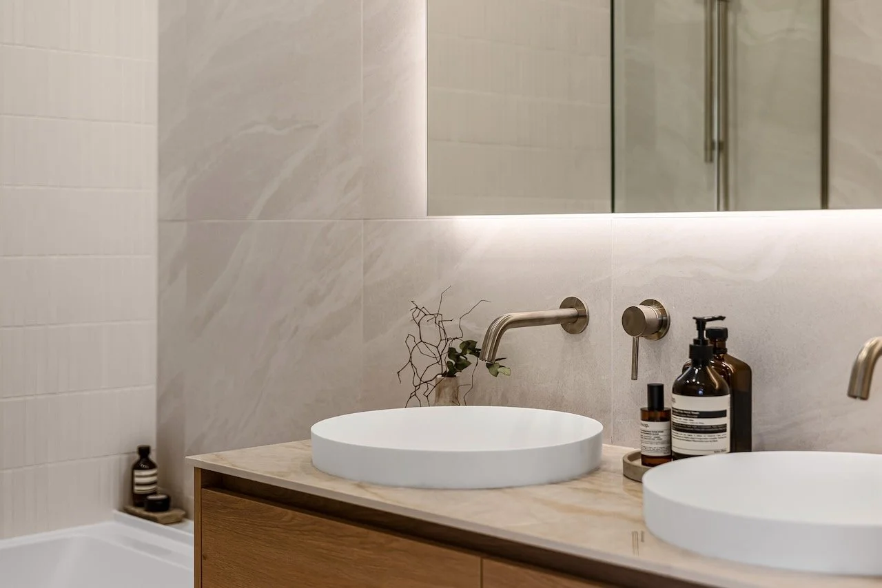 Bathroom LED mirror with stone bench and wooden vanity