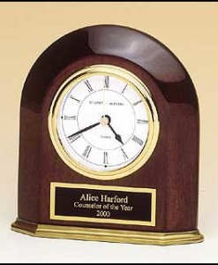 Arched Table Clock Rosewood Piano Finish arched table clock with solid brass base. Price of $92.00 includes 3 lines of engraving. Overall size is 5 5/8″ x 5 7/8″ x1 5/8″. Lifetime guaranteed movement.