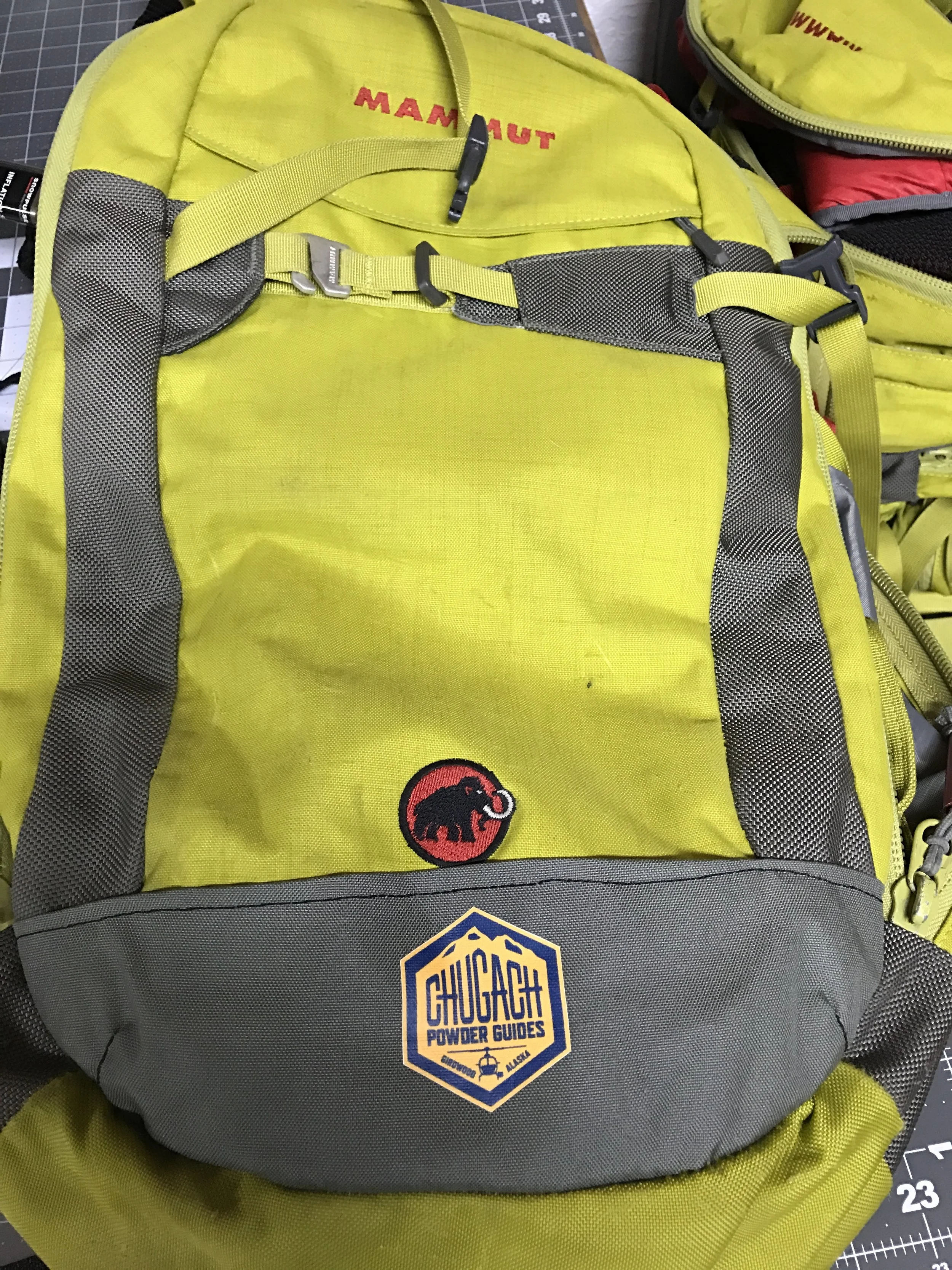 This patch panel covers holes worn through the pack by the heli-ski basket on the helicopter. Notice the contoured construction to match the pack shape.
