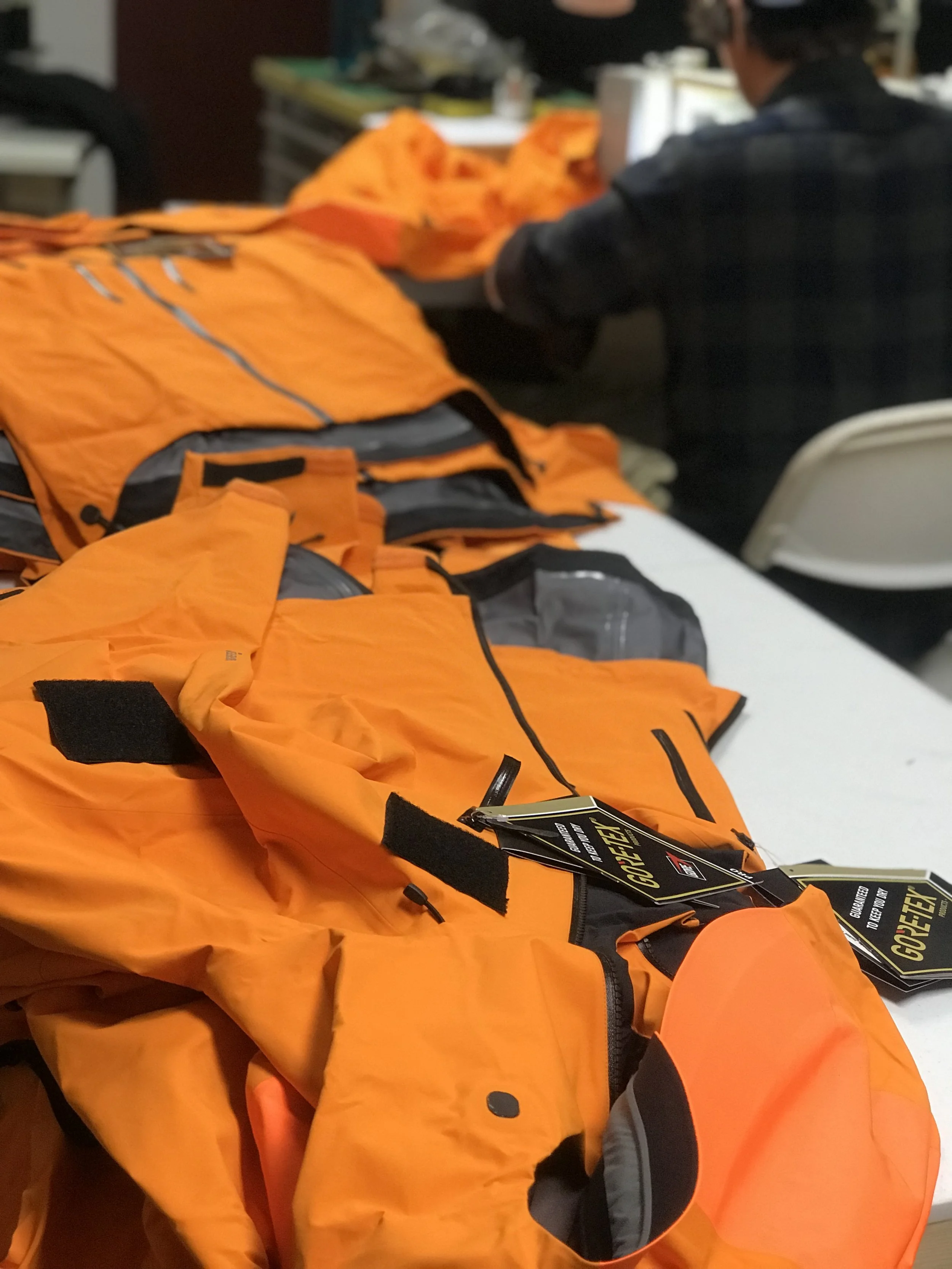 Applying Velcro® patches to Gore-Tex® jackets for Denali NPS Climbing Rangers. Fully seam taped.
