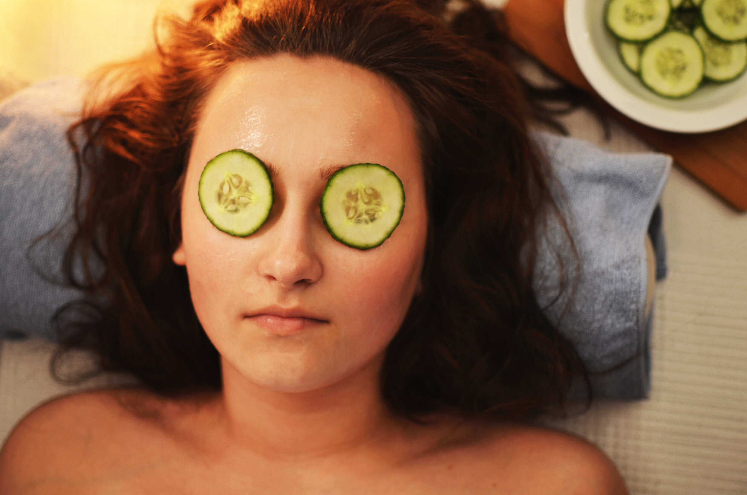 Canva - Woman Lying on White Textile With Sliced Cucumbers on Her Eyes.jpg